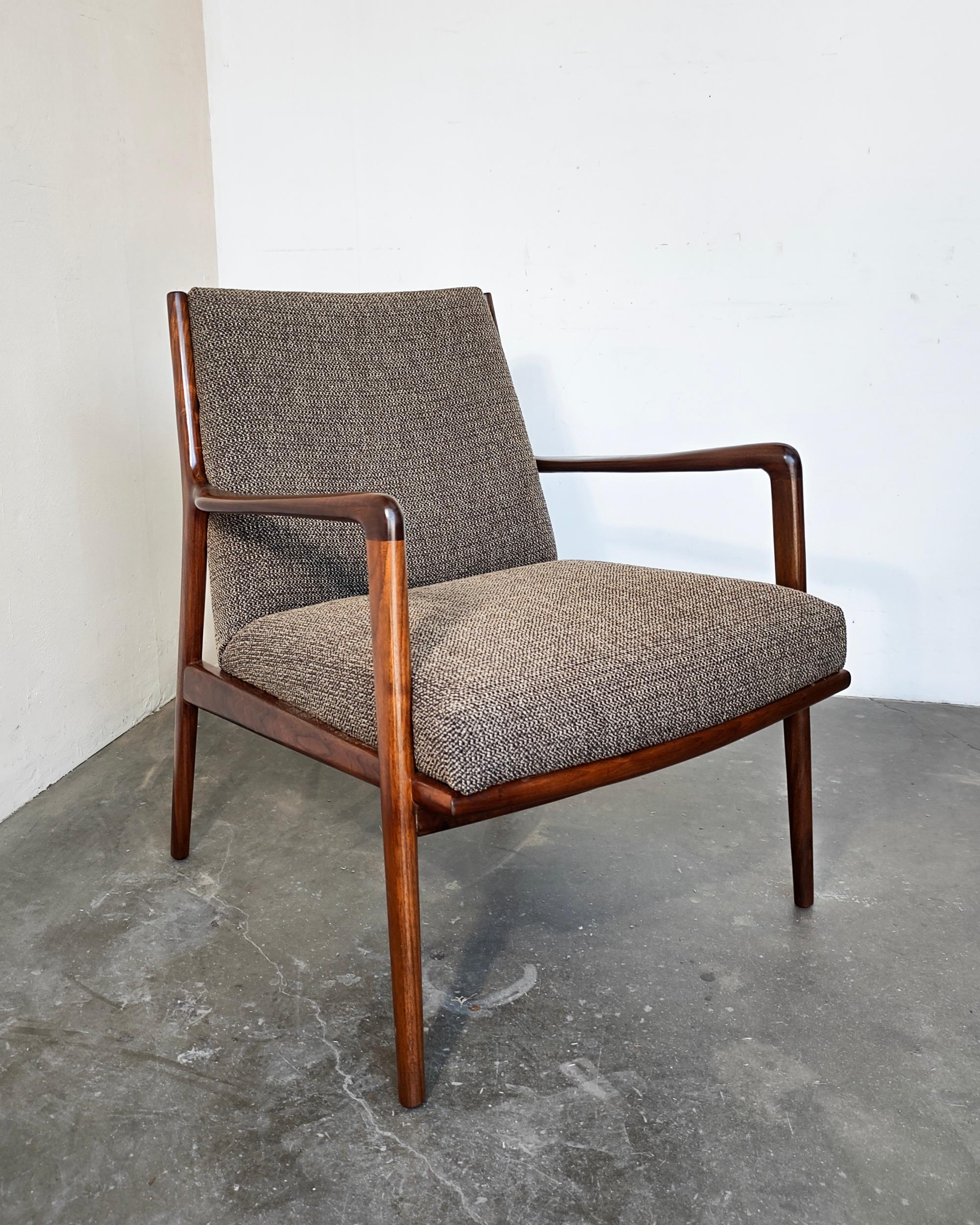 Refinished solid walnut mid-century modern Danish lounge chair. Restored vintage condition with semi-gloss oil-rubbed finish to showcase beautiful wood grain. New dark multi-color tweed upholstery. Overall excellent condition, some very light wear