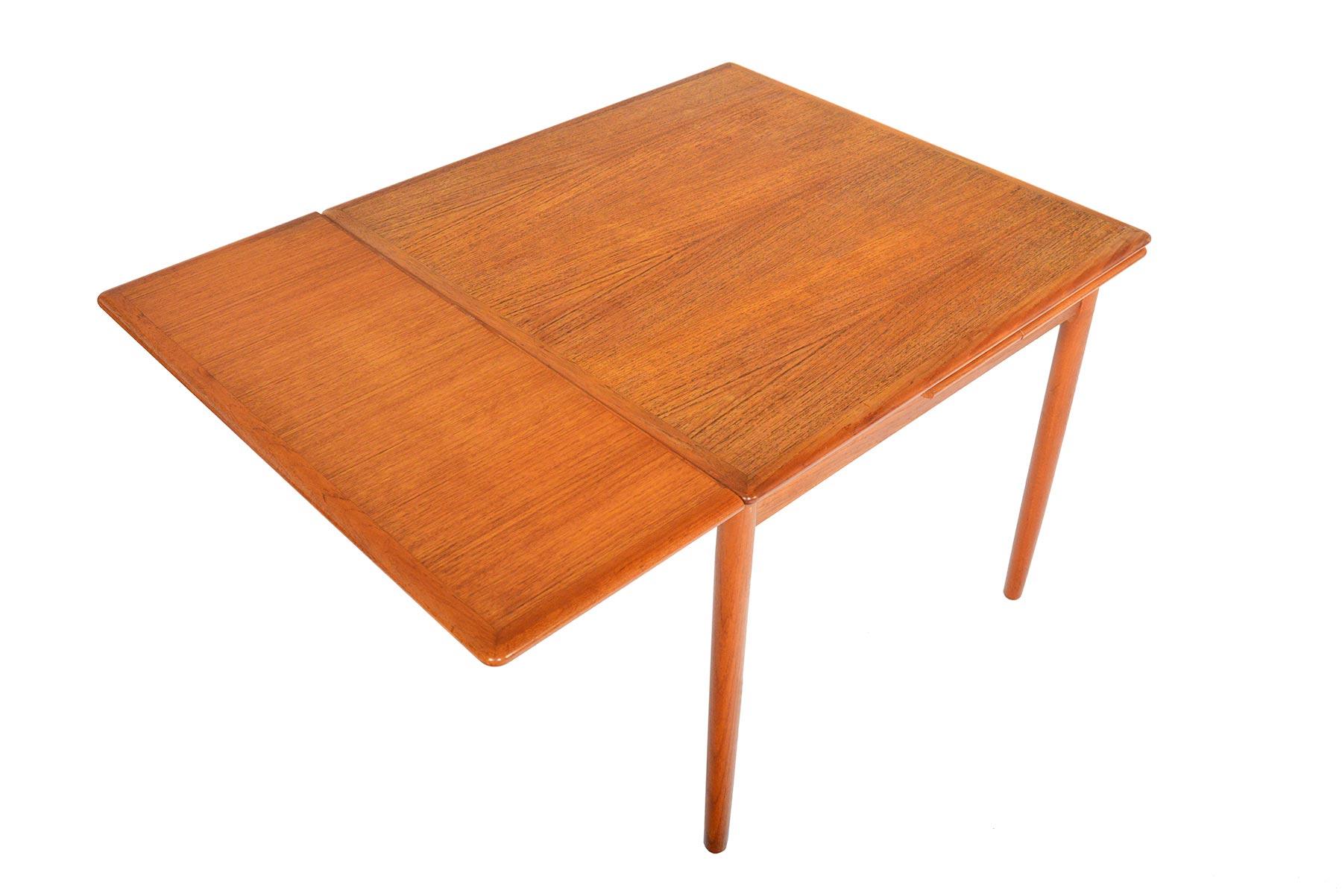 This fantastic Danish modern square draw-leaf dining table is crafted in teak. Perfect for smaller dining rooms or kitchens, this dining table offers a small footprint. When the two leaves are extended, the table nearly doubles in size. Great for