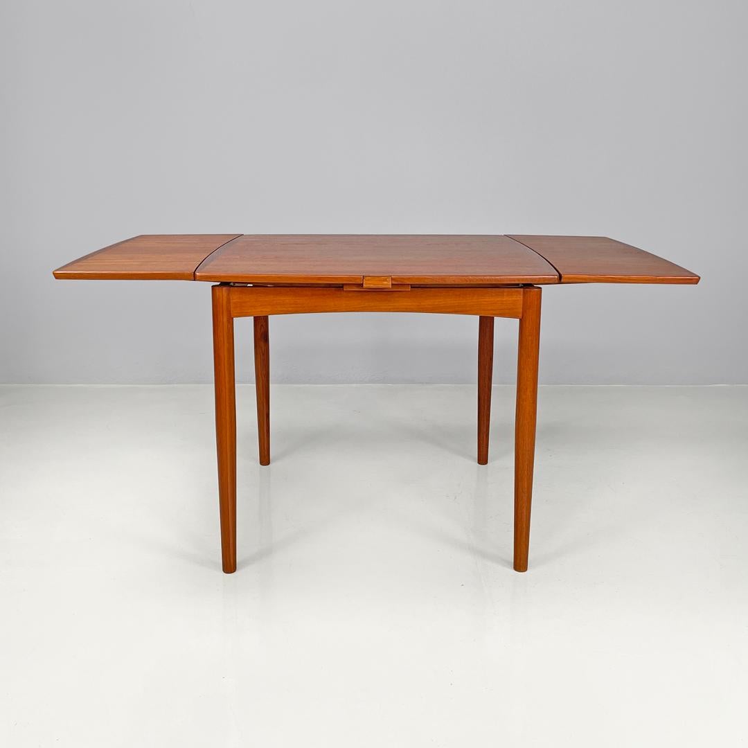 Danish mid-century modern square wood dining table with side extensions, 1960s
Square wooden dining table. The top is extractable. It has two side extensions which, once opened, make the top rectangular. With four round section legs.
1960s. Logo