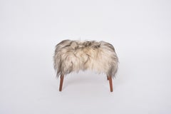 Danish Mid-century Modern stool reupholstered in white and black sheep skin