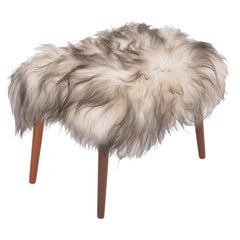 Danish Mid-century Modern stool reupholstered in white and black sheep skin