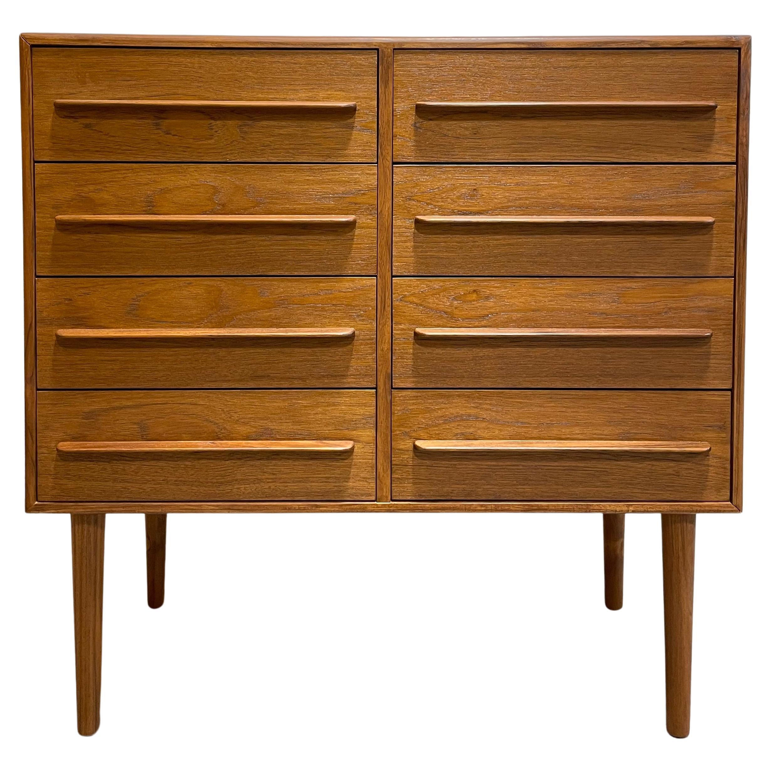 Exceptional Mid-Century Modern styled Teak Handmade dresser with eight drawers. Knife edge drawer pulls and long tapered legs. Perfect as a bedroom dresser, nursery or entryway cabinet. Finished back.