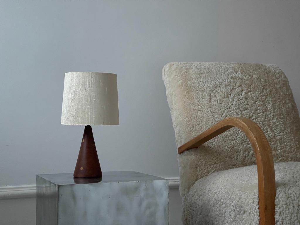 Original table lamp by Mid-Century Danish Modern cabinet maker The elegant cone shaped table lamp is in solid teak and elm tree dots. Original shade of natural raw silk.