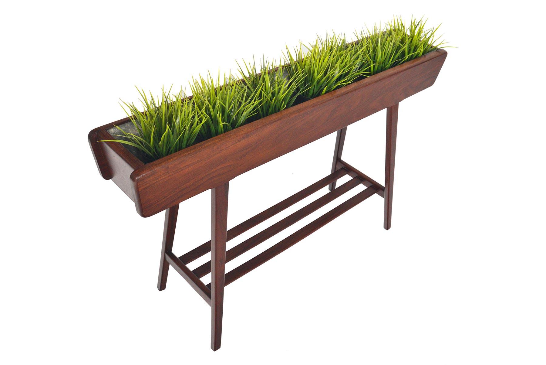 Tall and atomic, this Danish modern teak planter is the perfect piece to elevate your indoor gardening! Organic angles and canted legs offer a dramatic Silhouette from every angle. In excellent original condition with typical wear for its