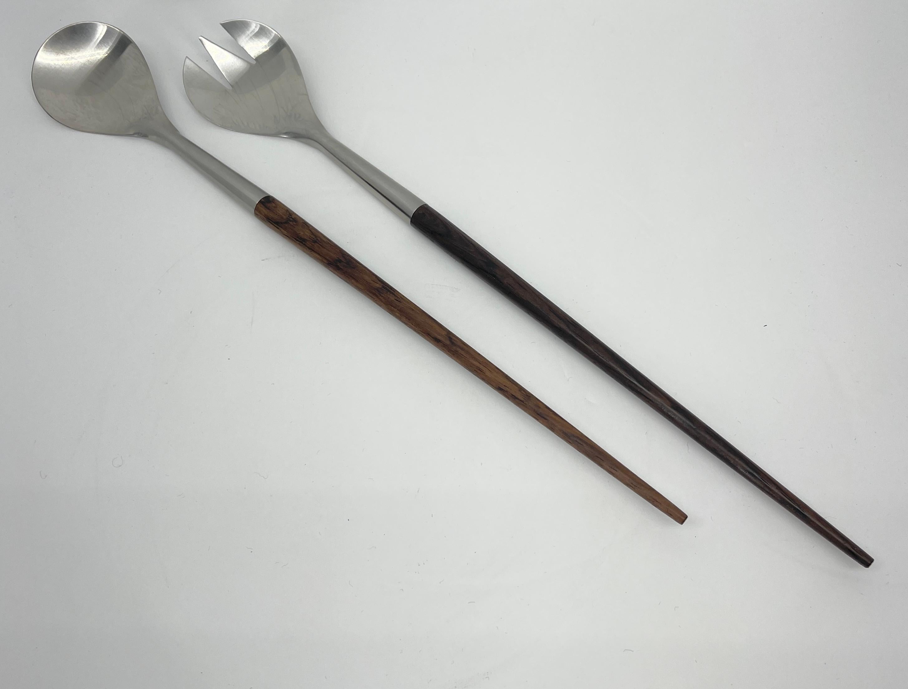 Danish teak and stainless steel salad tongs, Mid-Century Modern. Classic lean and clean set of salad serving tongs are perfect serving pieces for your modern serving needs. Beautiful warm wood and stainless steel, these tongs have many functions and