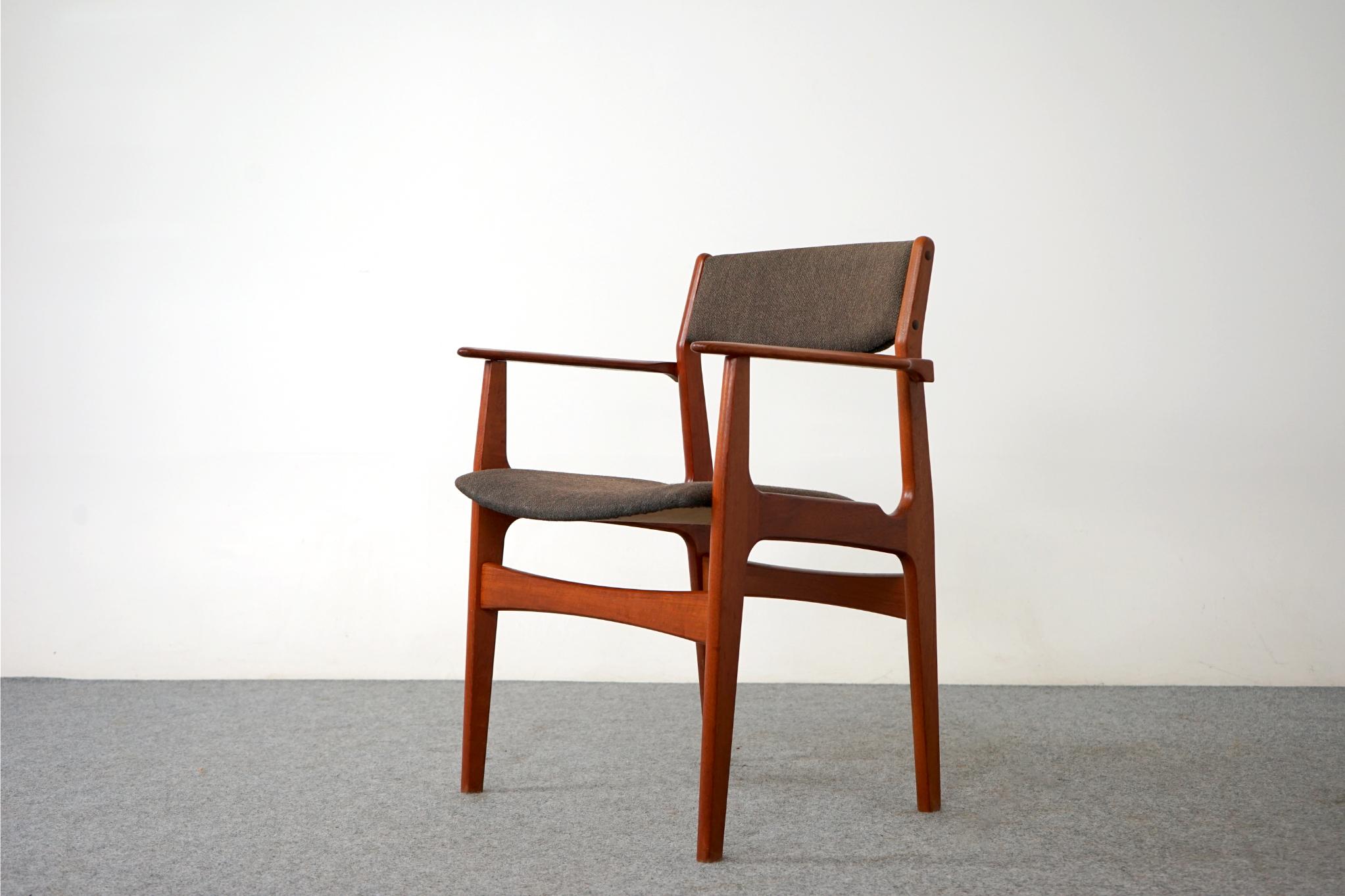 Teak arm chair, circa 1960's. Solid wood frame with upright upholstered back provides support and comfort. This beautifully sculpted frame offers comfort without an imposing footprint. Clean modern design makes it easy to combine with other