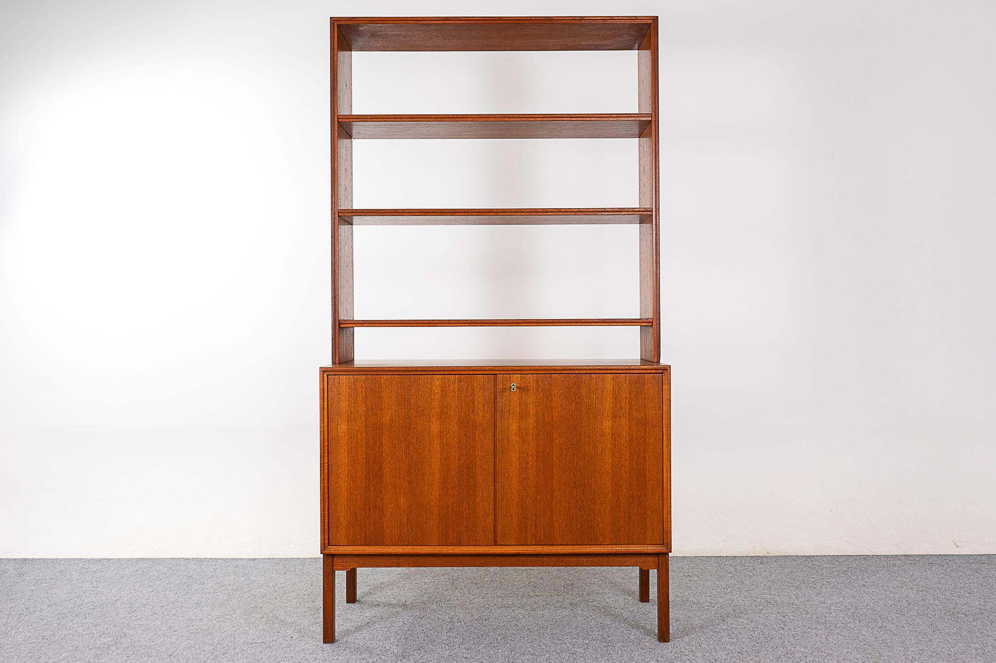 Teak Danish bookcase/cabinet, circa 1960's. Backless top with 3 adjustable shelves allows your wall color to show through, for a light, airly feel. Locking cabinet with height adjustable shelf. Great condition, warm, rich tone. Pieces can be used