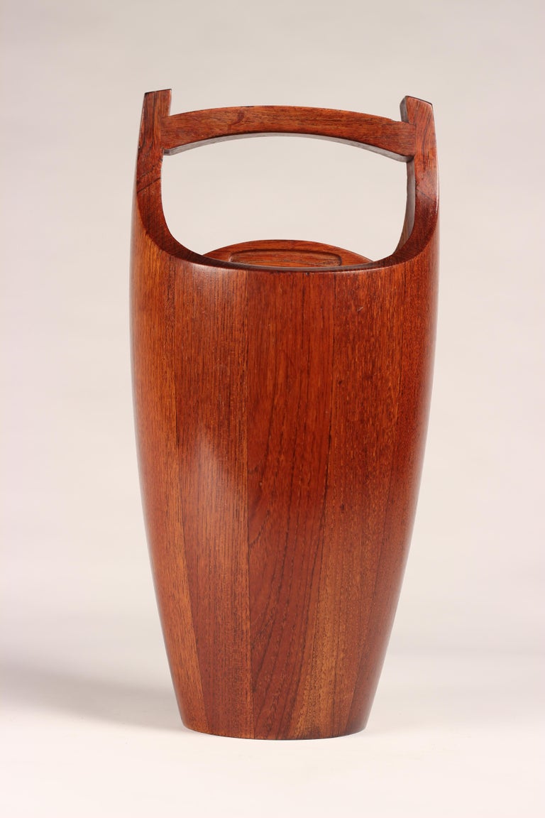 A fine example of a Scandinavian Modern teak ice bucket designed by Jens Quistgaard, a master of the sculptural paired back and simplistic form. This teak ice bucket has had its wood sympathetically and selectively chosen in order to create an