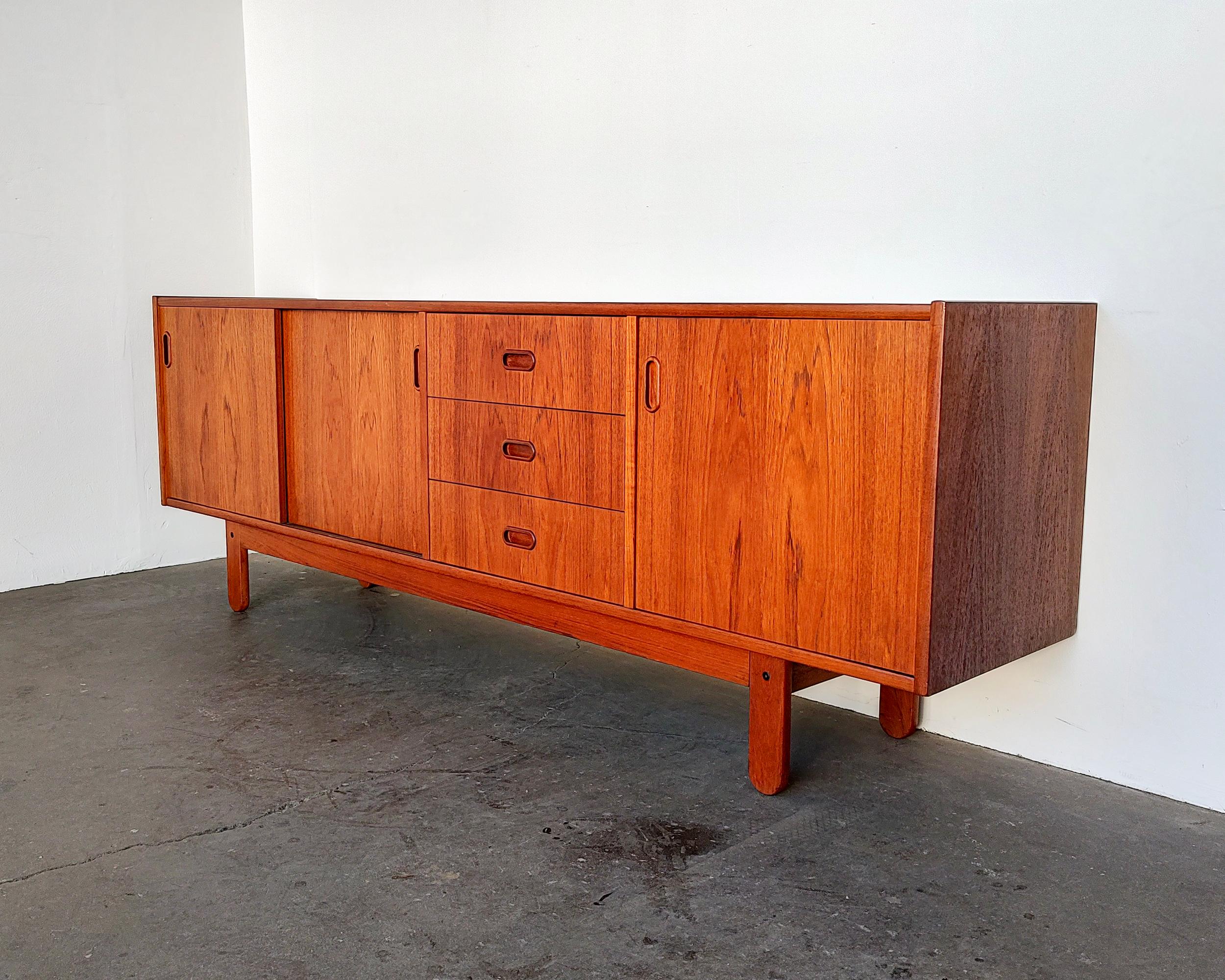 Beautiful Danish modern teak wood credenza by Bramin Møbler circa 1960s. Sliding doors on the left open to an adjustable shelf, three drawers with dovetail joinery and one opening cabinet door on the right. Overall excellent condition, some very