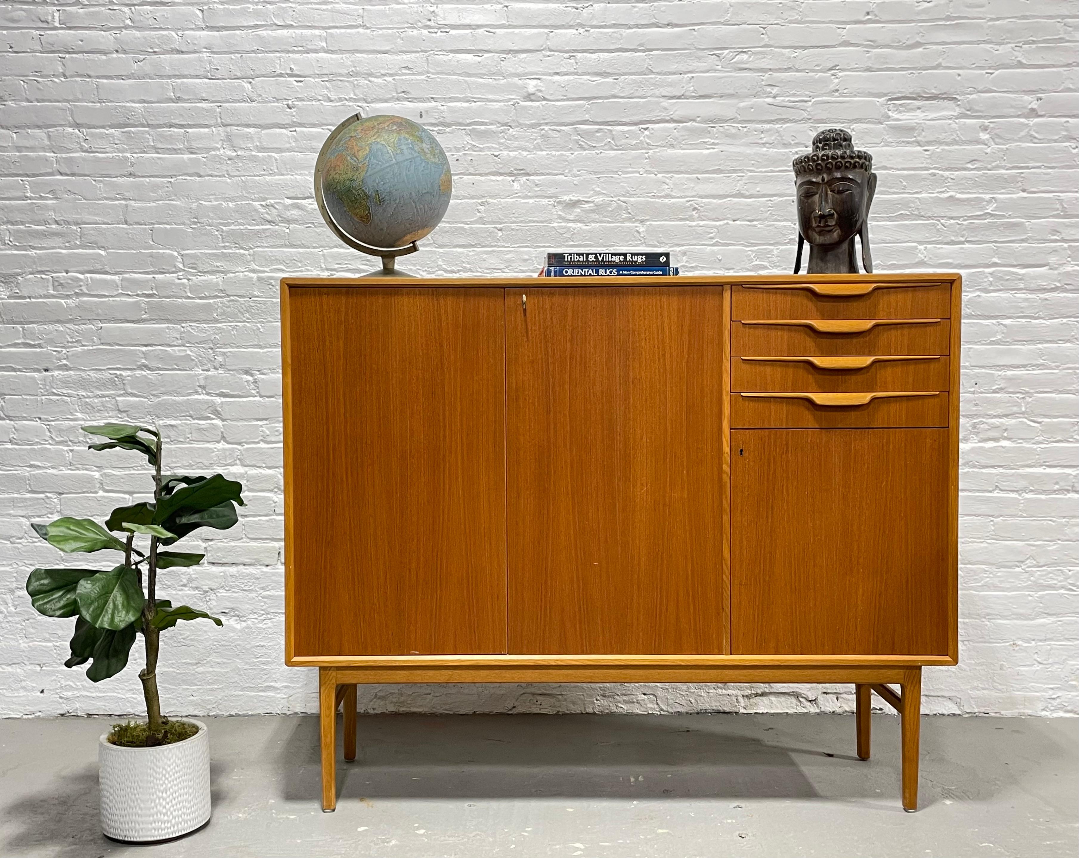 Mid-Century Modern Danish teak highboard credenza / sideboard by Beril Fridhagen for Bodafors, c. 1960's. This incredible piece is gorgeous in its simple yet extremely functional design. This beauty offers double lockable doors (key included!) with
