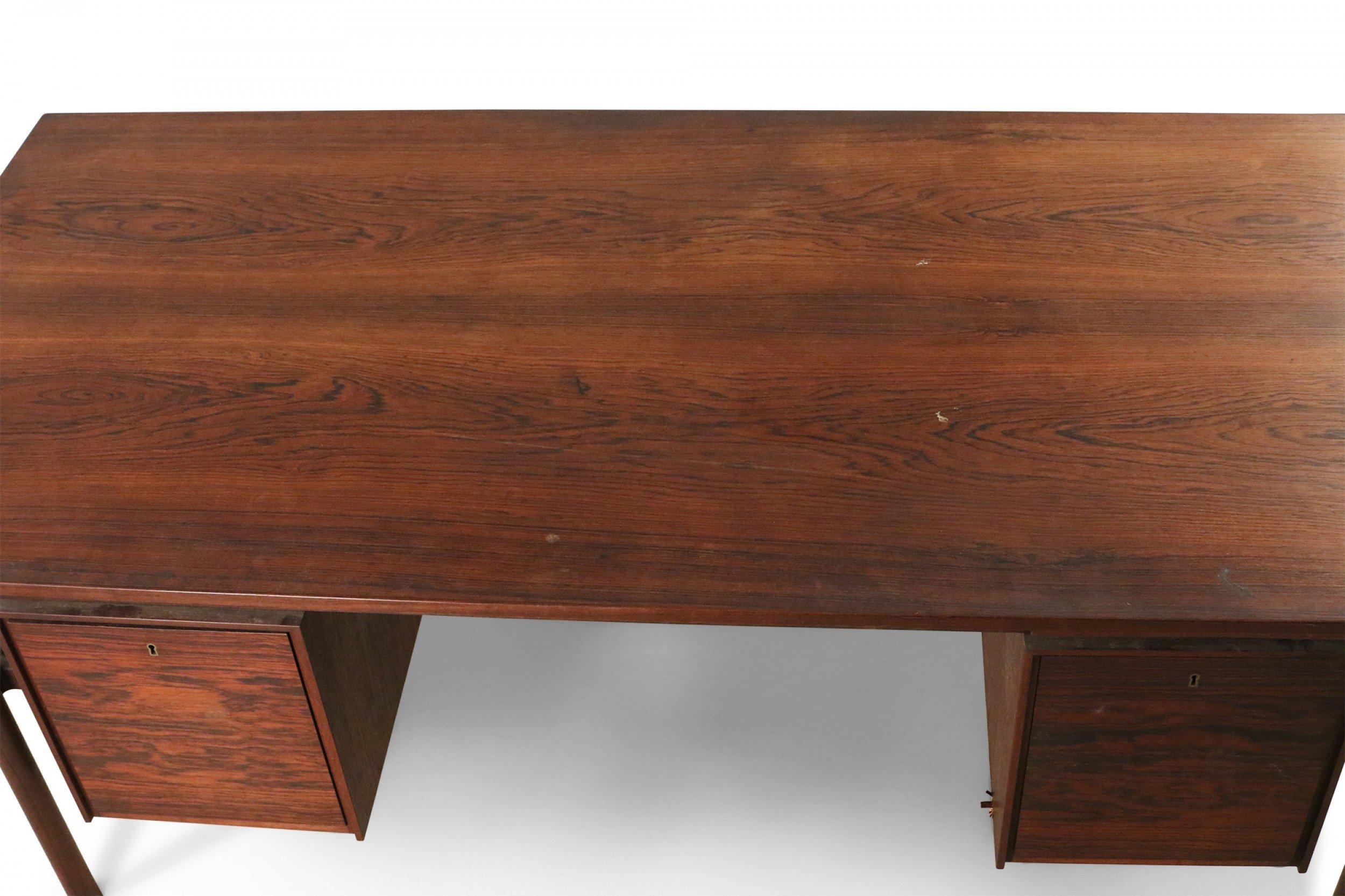 Mid-century Danish teak desk with rectangular top and two sets of drawers float-mounted under the desktop (2 drawers on left, 3 drawers on right).
  