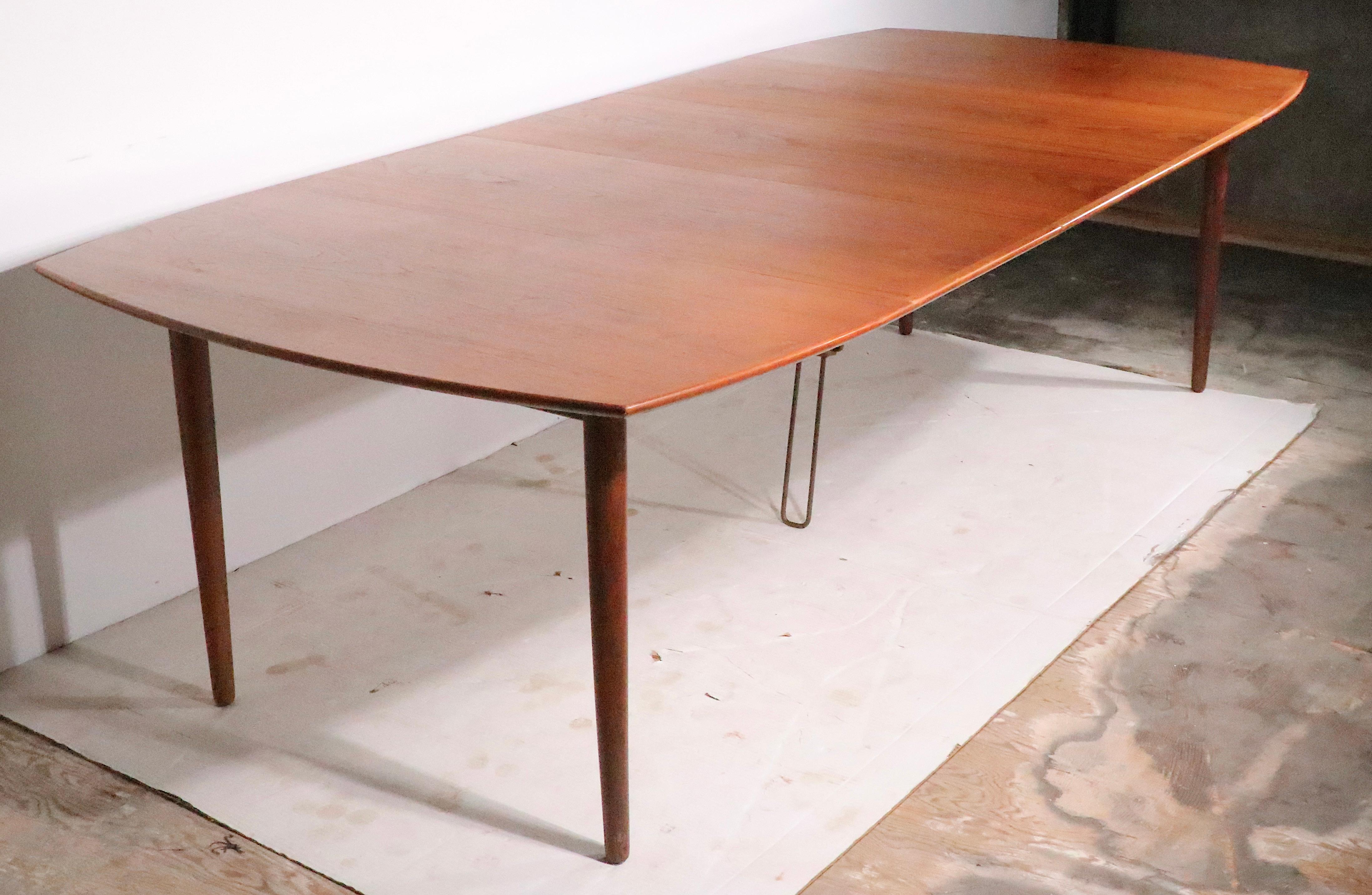 Exceptional  Danish Mid Century Modern teak dining table with 3 leaves. Designed by H. W. Klein, for Bramin Mobler, this example  is in very good, original condition, showing only light cosmetic wear, normal and consistent with age.
 The table