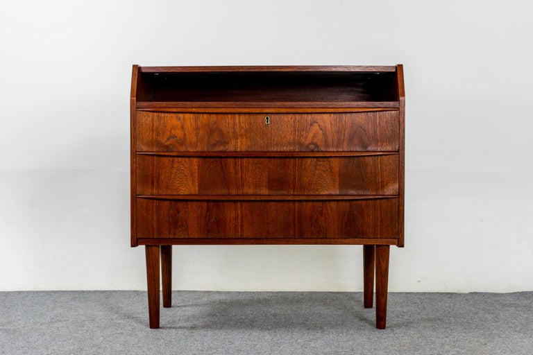 Teak Danish mid-century flip top vanity, circa 1960's. Very stylish dresser and mirror combination, a must have for those with limited space and discerning taste! Compact functional vanity with solid wood trim and stunning book-matched veneer on