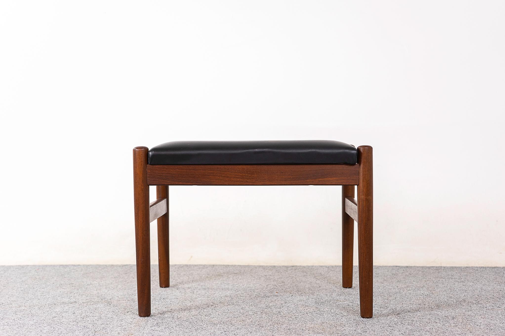 Teak Danish footstool, circa 1960's. Elegent, robust design with cross supports. Original black vinyl uphostery.


