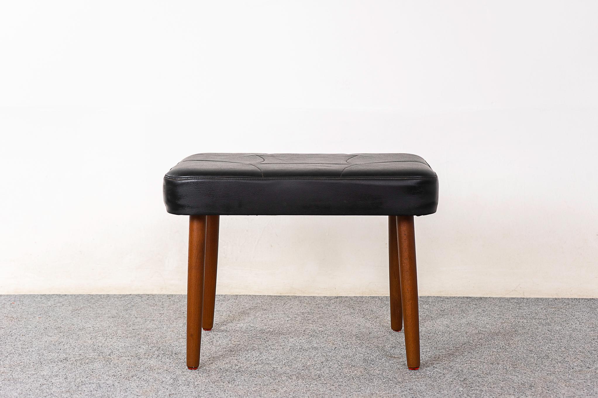 Teak Danish footstool, circa 1960's. Tapering, sleek removable legs and original vinyl upholstery. 


