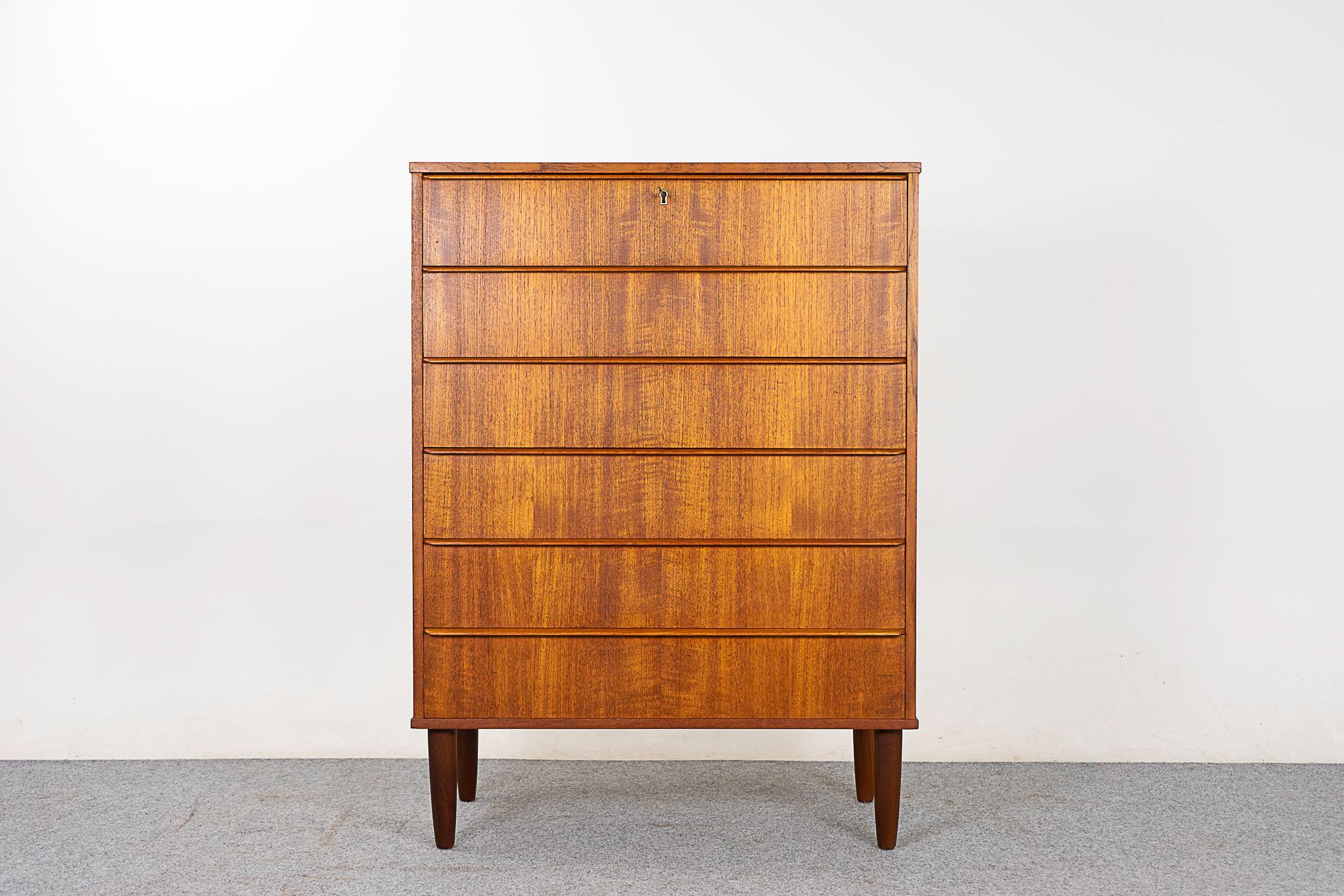 Teak midcentury highboy dresser, circa 1960s. Solid wood edging with stunning book-matched veneer on all drawer faces. Dovetail construction and integrated horizontal drawer pulls. Afromosia tapered legs. Darling!

Please inquire for international