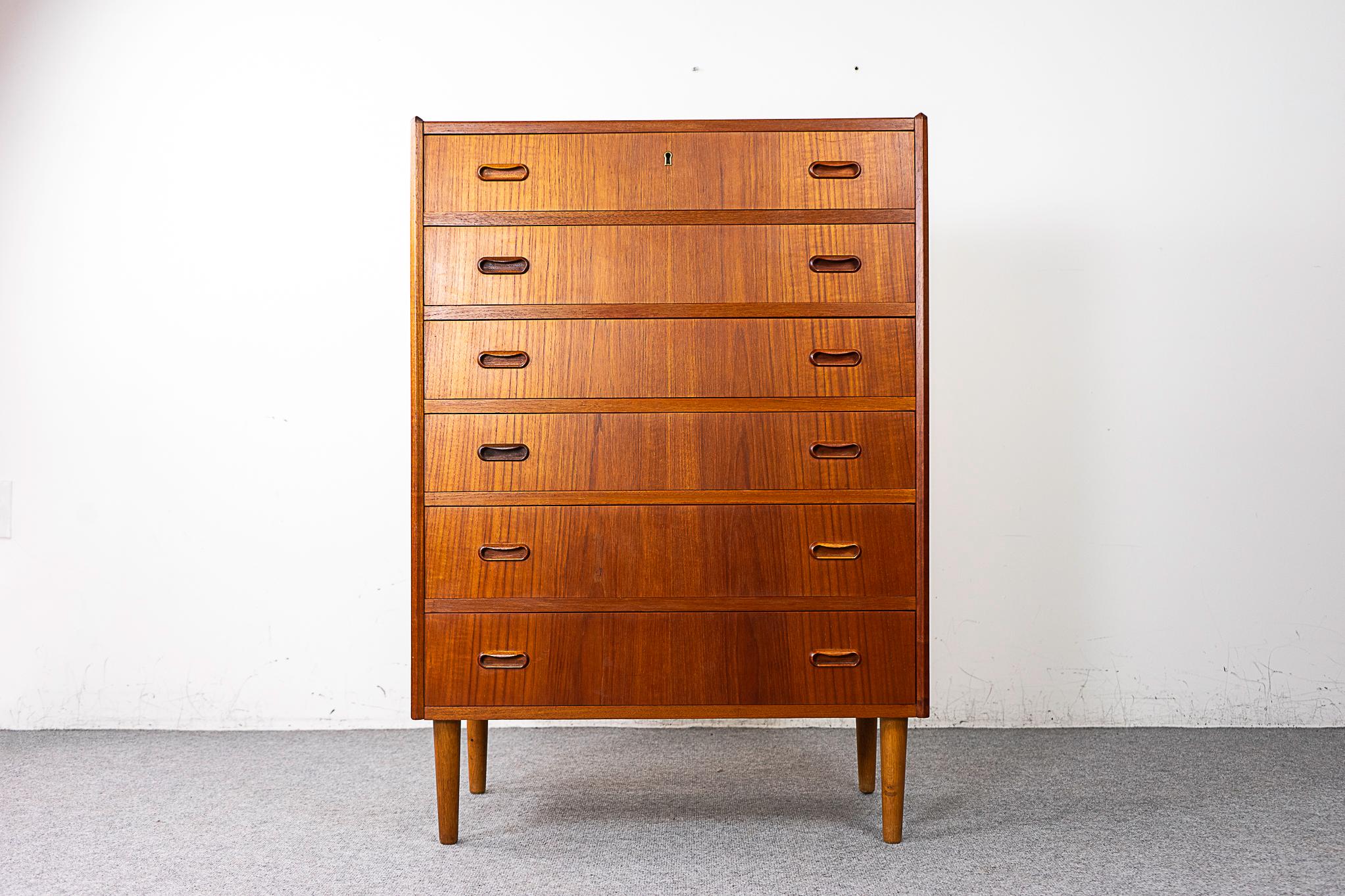 Teak mid-century dresser, circa 1960's. Solid wood edging and stunning book-matched veneer on top and drawer faces. Dovetail construction, cute handles and tapering, elegant legs.

Please inquire for remote and international shipping rates.