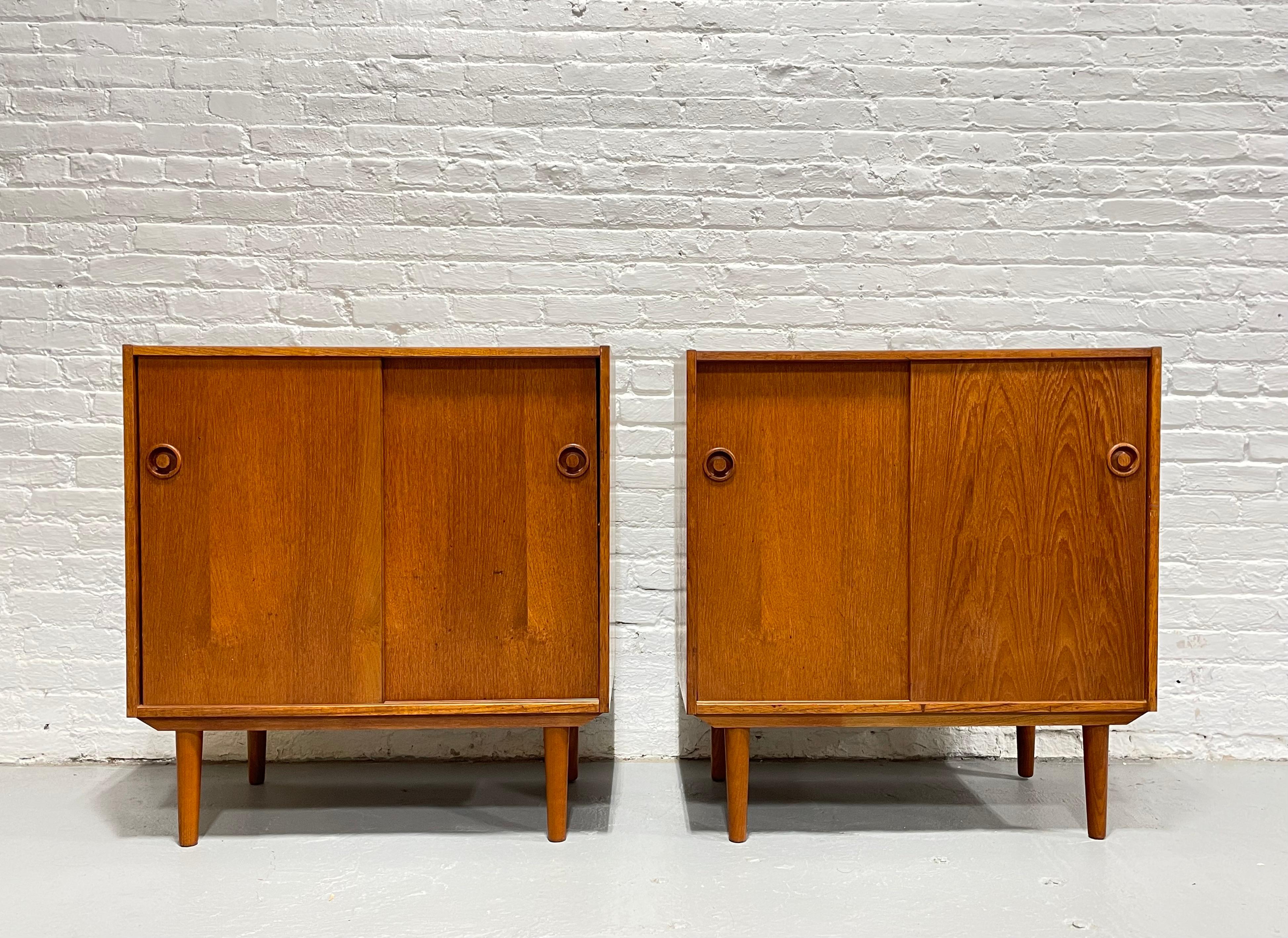 Pair of Mid Century Modern Teak Jr. Credenzas / Storage Cabinets, c. 1960's.  While small and streamlined, this pair offers a vast amount of storage space, enough for several components above and below the shelf if used as a media stand or