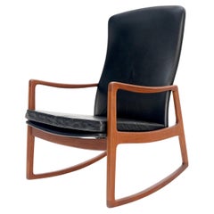 Fauteuil à bascule danois moderne du milieu du siècle dernier en cuir de teck rembourré MINT !