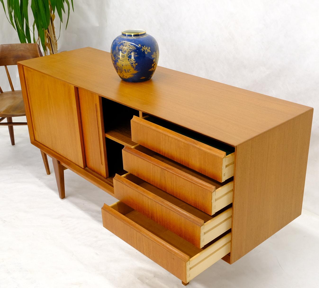 Mid-Century Modern take long condenser dresser. with two sliding doors compartment adjustable shelves and four drawers. Made in Denmark for Maurice Villency.