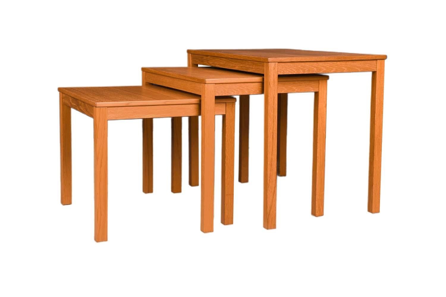 Set of three Mid-Century Modern teak, rectangular nesting tables. Exceptionally well crafted. Undersides of the tables are channeled so that the tables hook to one another when nested, forming an attractive profile. The wood grain is naturally