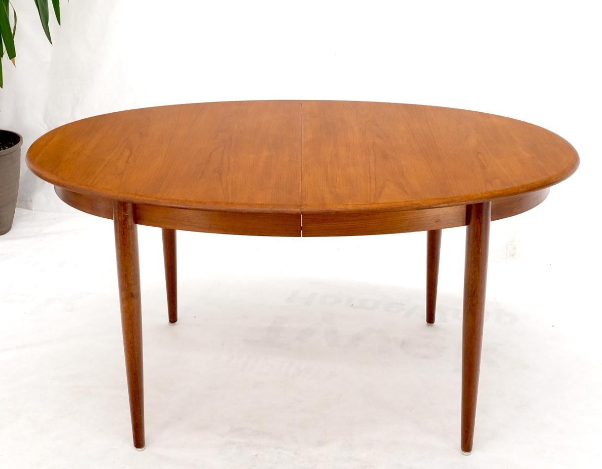 Danish Mid-Century Modern oval teak dining table with 2x19