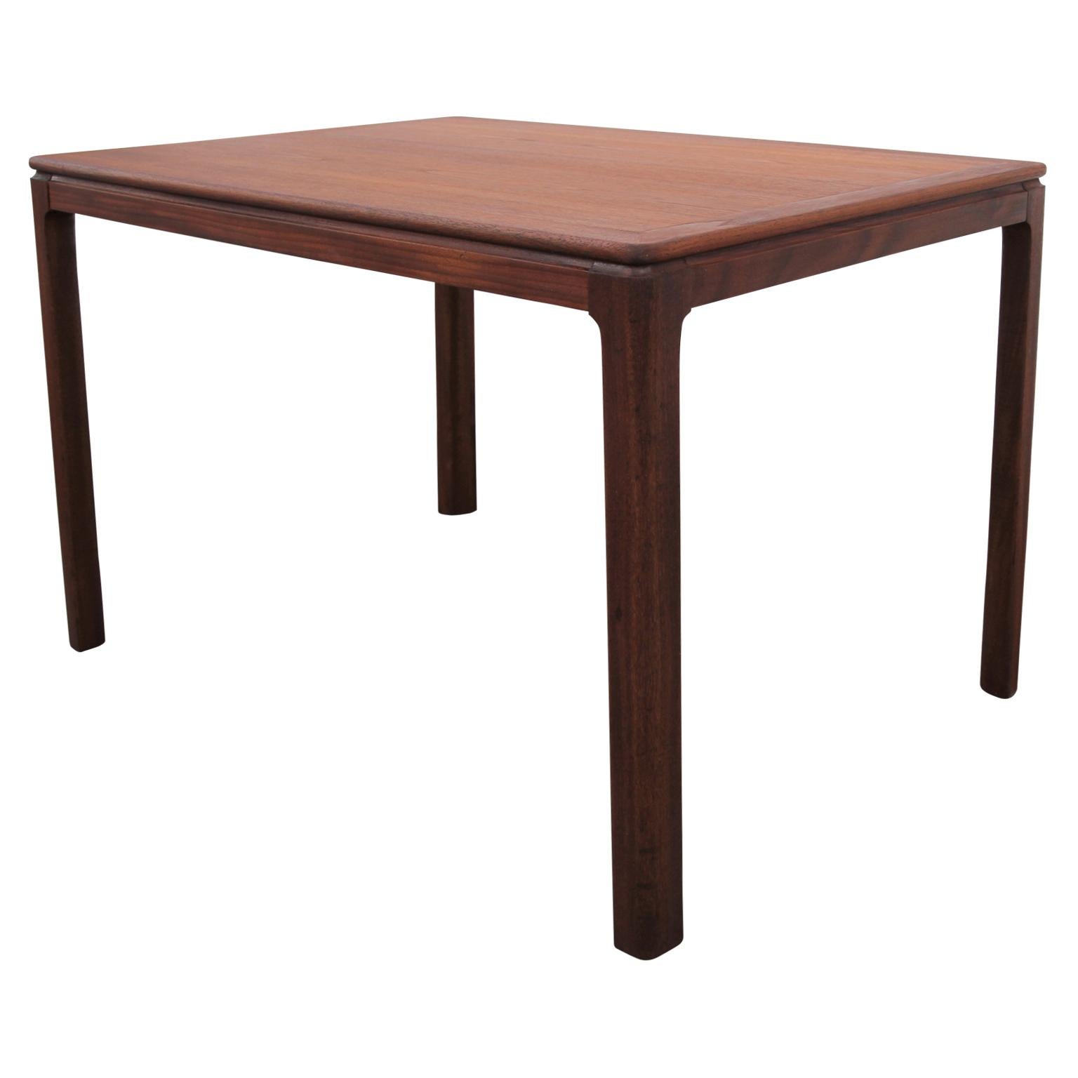 Danish rectangular side table in the Mid-Century Modern style. The tabletop and legs are beautifully constructed from teak. Restored.