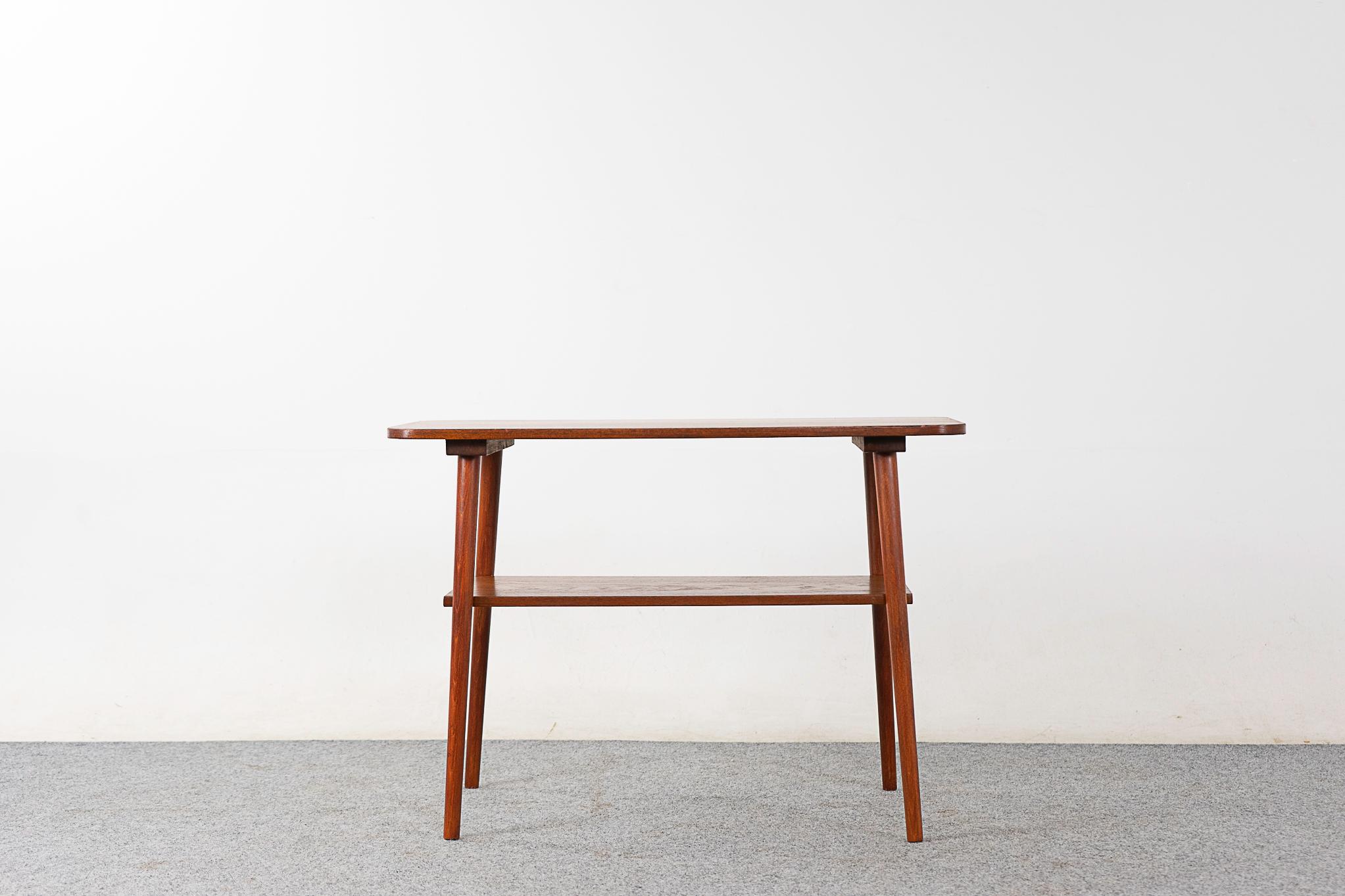 Teak Danish side table, circa 1960's.  Darling little table with solid teak construction on the base and handsome book-matched teak veneer on the top. Handy shelf too!

Please inquire for remote and international shipping rates.
