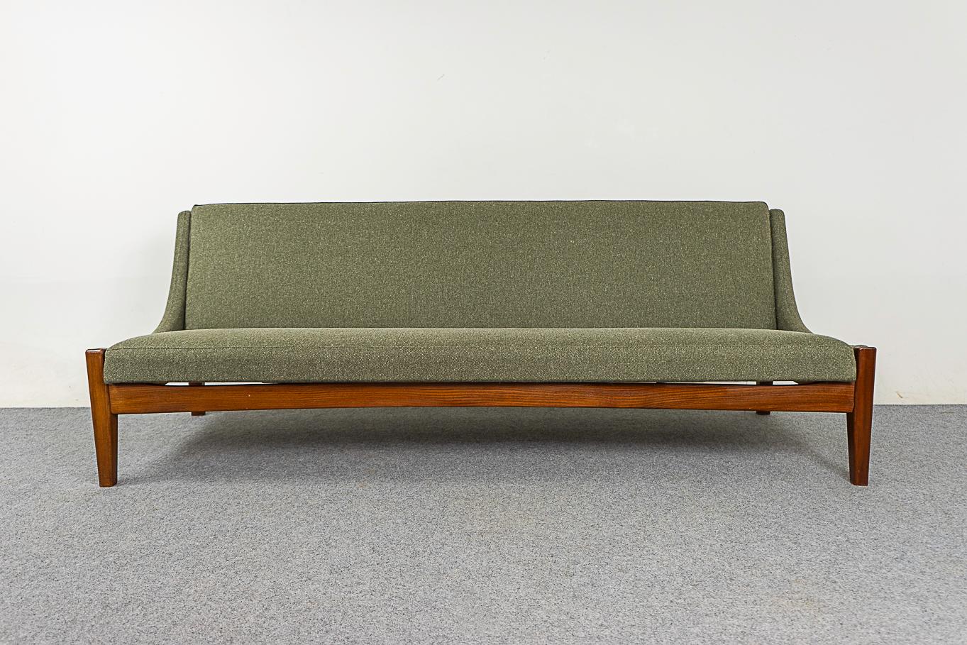 Teak Danish sofa bed, circa 1960's. Solid teak construction, fresh long-lasting foam, new sage green quality silk & wool upholstery, with a lovely feel to it! Transformative design allows it to flattens out into a comfortable bed!

77