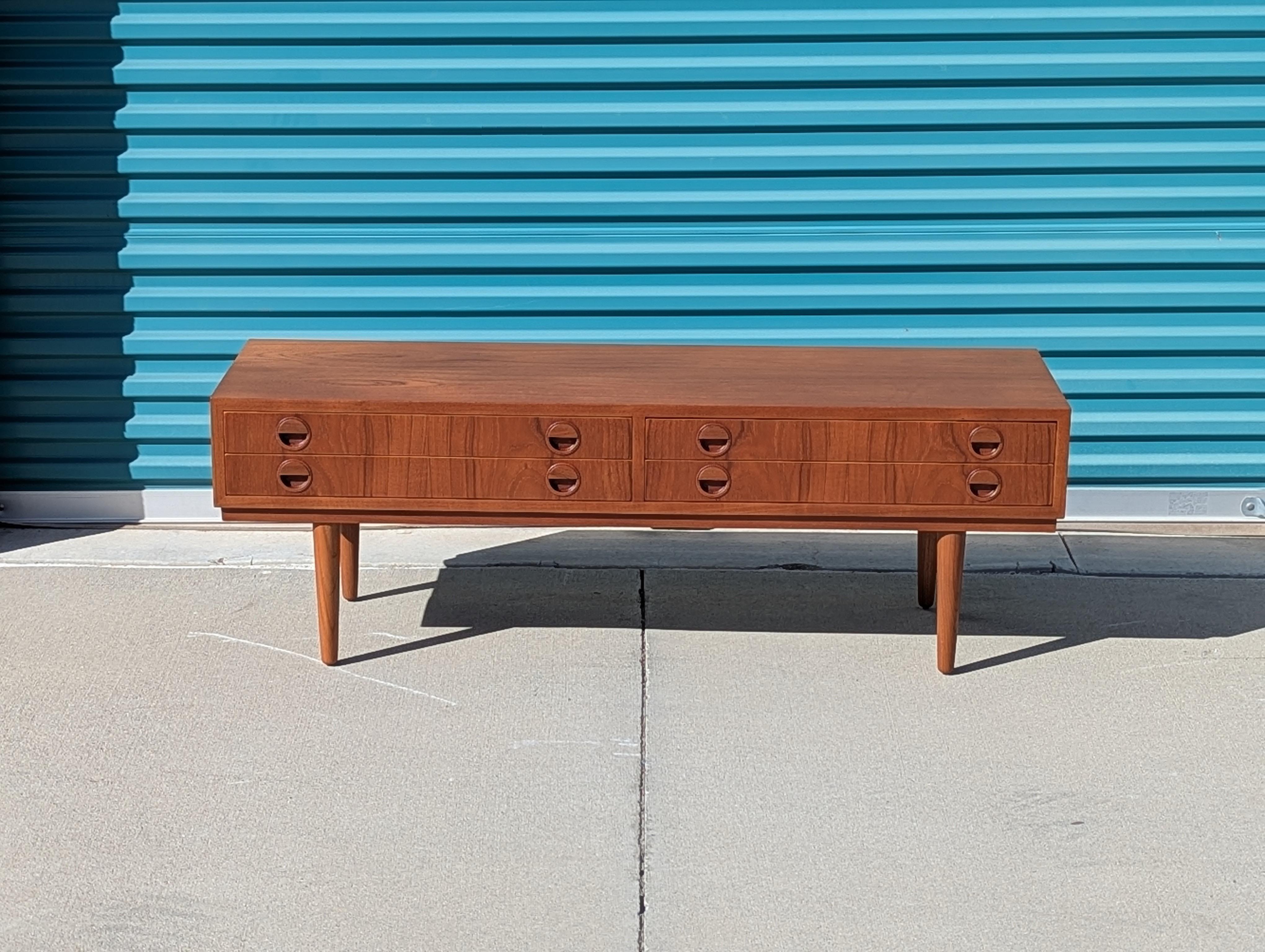 For sale is a stunning Vintage Danish Mid Century Modern Teak Console Table by the renowned designer Carlo Jensen, dating back to the 1960s. This exquisite piece embodies the perfect blend of form and function, showcasing the timeless elegance of