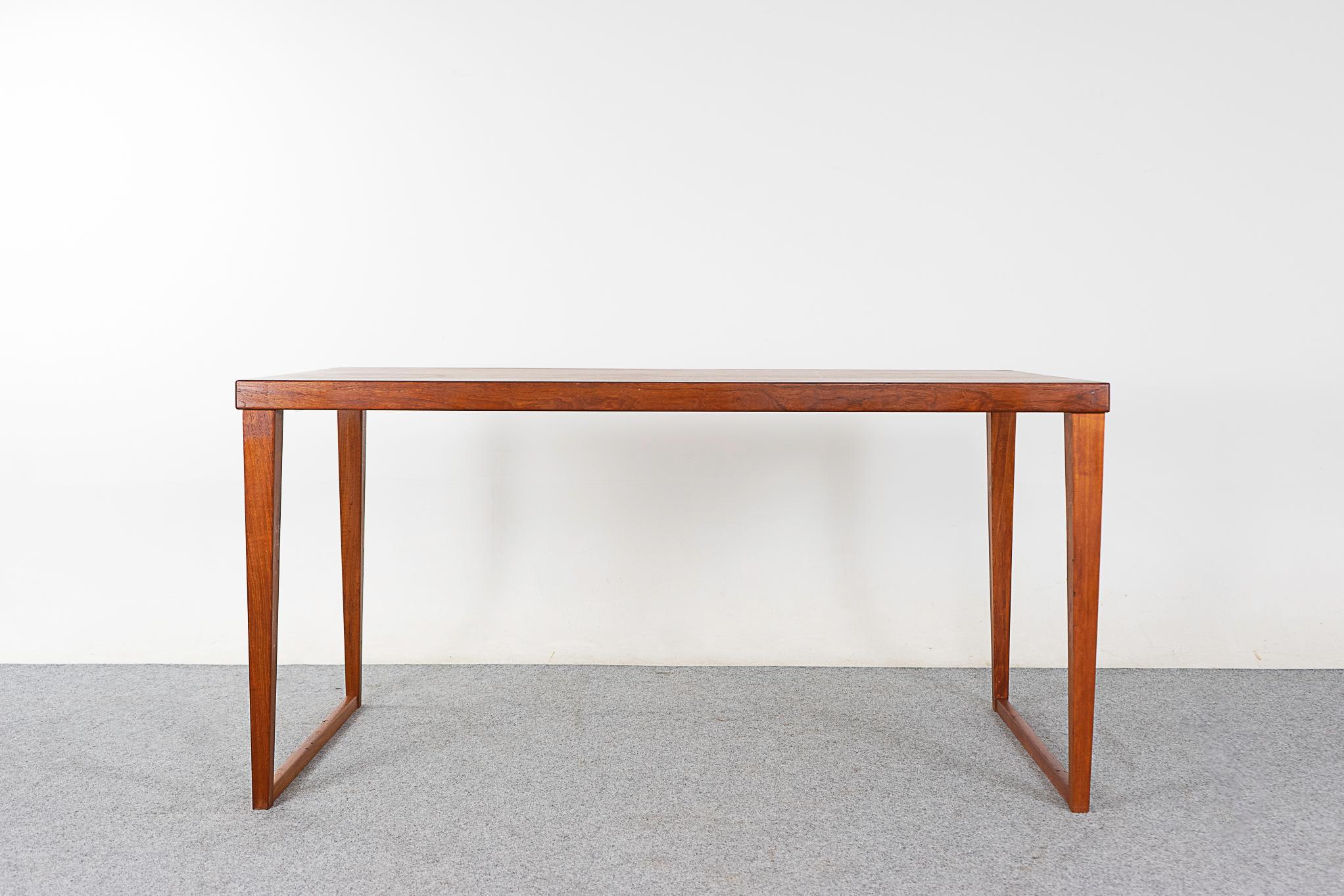 Teak mid-century desk/table, circa 1960's. Unique piece, perfect for the dining room or office, double duty! Striking silhouette with angled base.

Please inquire for remote and international shipping rates.