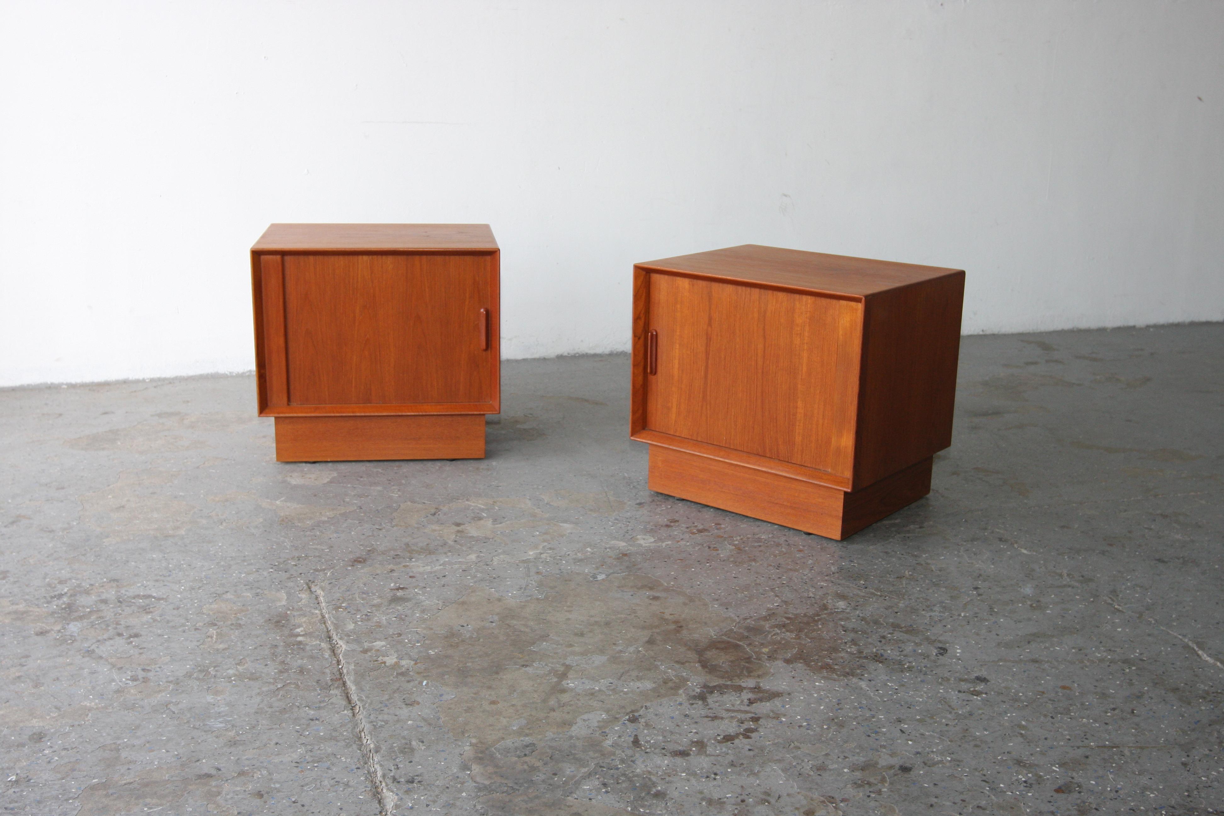 Classic set of  Danish Modern teak nightstands by Svend Madsen for Falster Moberlfrabrik of Denmark; featuring rolling tambour doors, adjustable shelve and single drawer.  Please see pictures and ask questions about anything. The tambour doors and