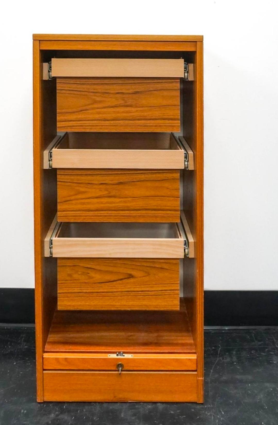 A  Danish Mid-Century Scandinavian Modern Fall Front Tambour Filing Cabinets featuring Three Open Drawers opening and closing. Tambour Fall front door flawlessly operating. Comes with locking key.
Dimensions:  19.5