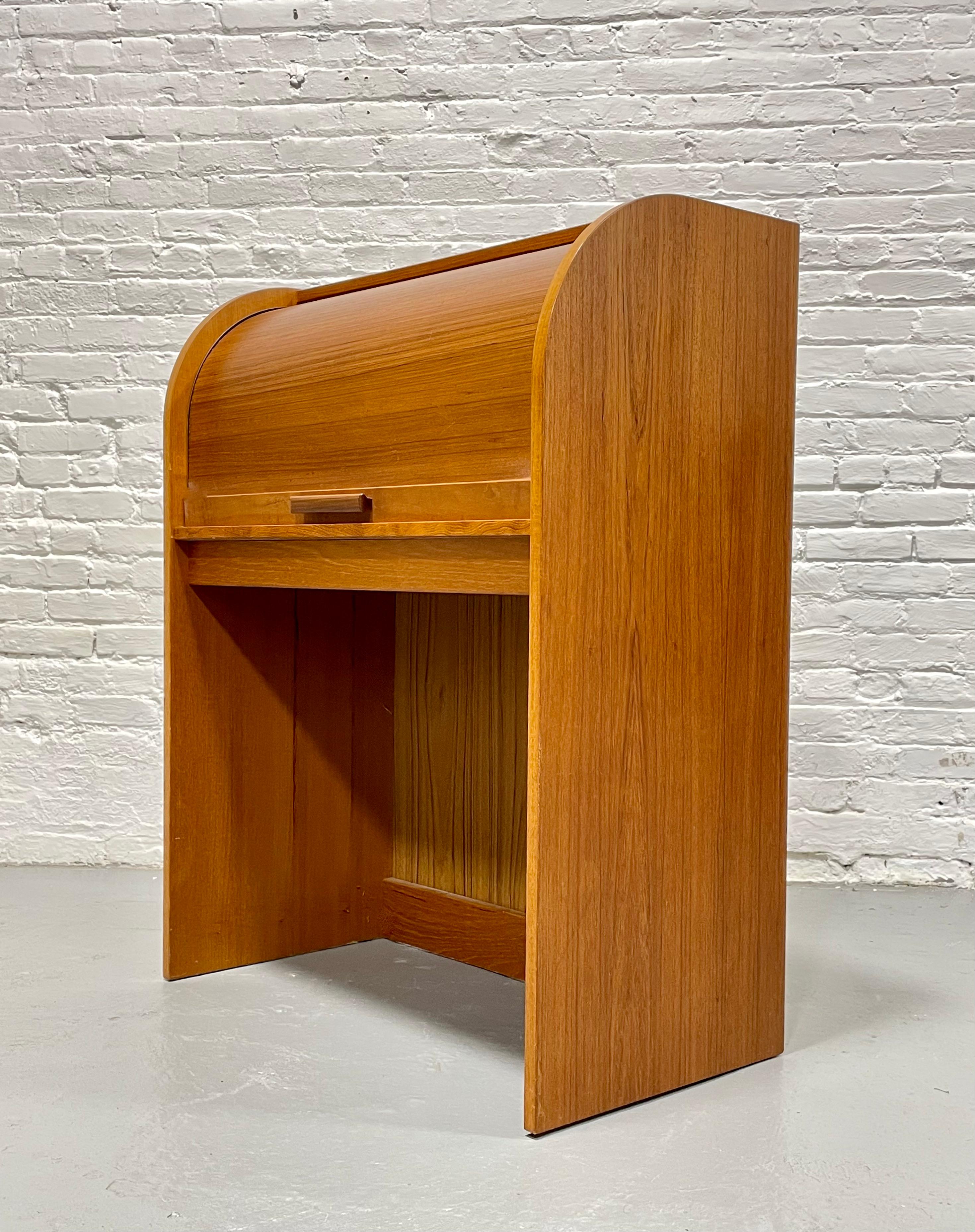 Danish Mid Century Modern Teak Tambour Secretary Desk, c. 1960's. Incredible profile with hidden pull out tabletop and open area below for your chair. Pull up a chair and do some work on your laptop with this creative space-saving mini office and