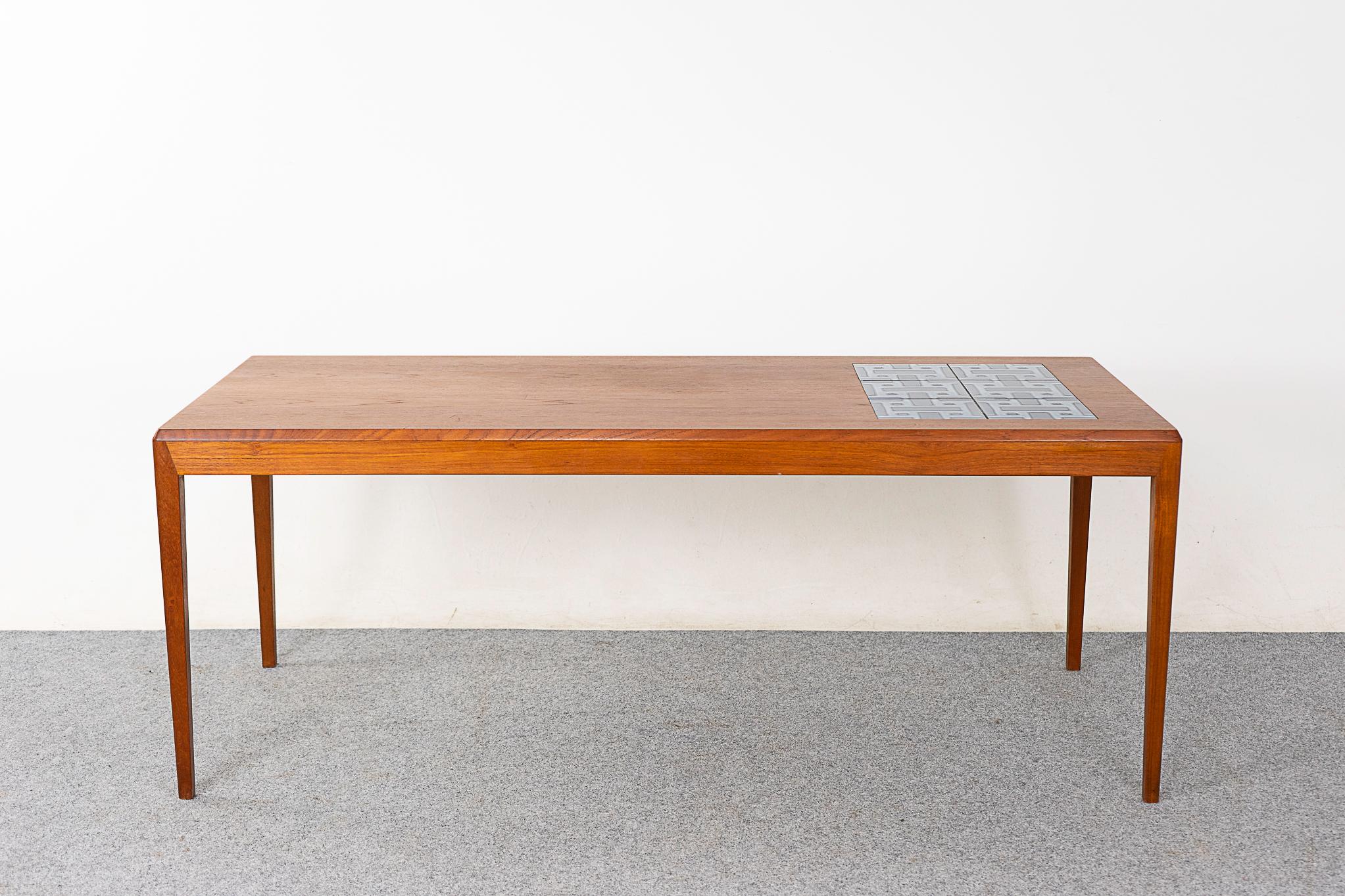 Teak & tile Danish coffee table, circa 1960's. Generously sized top surface with book matched veneer and vibrant ceramic tiles, ideal for beverages! Solid wood edging along the length and sleek tapering legs.