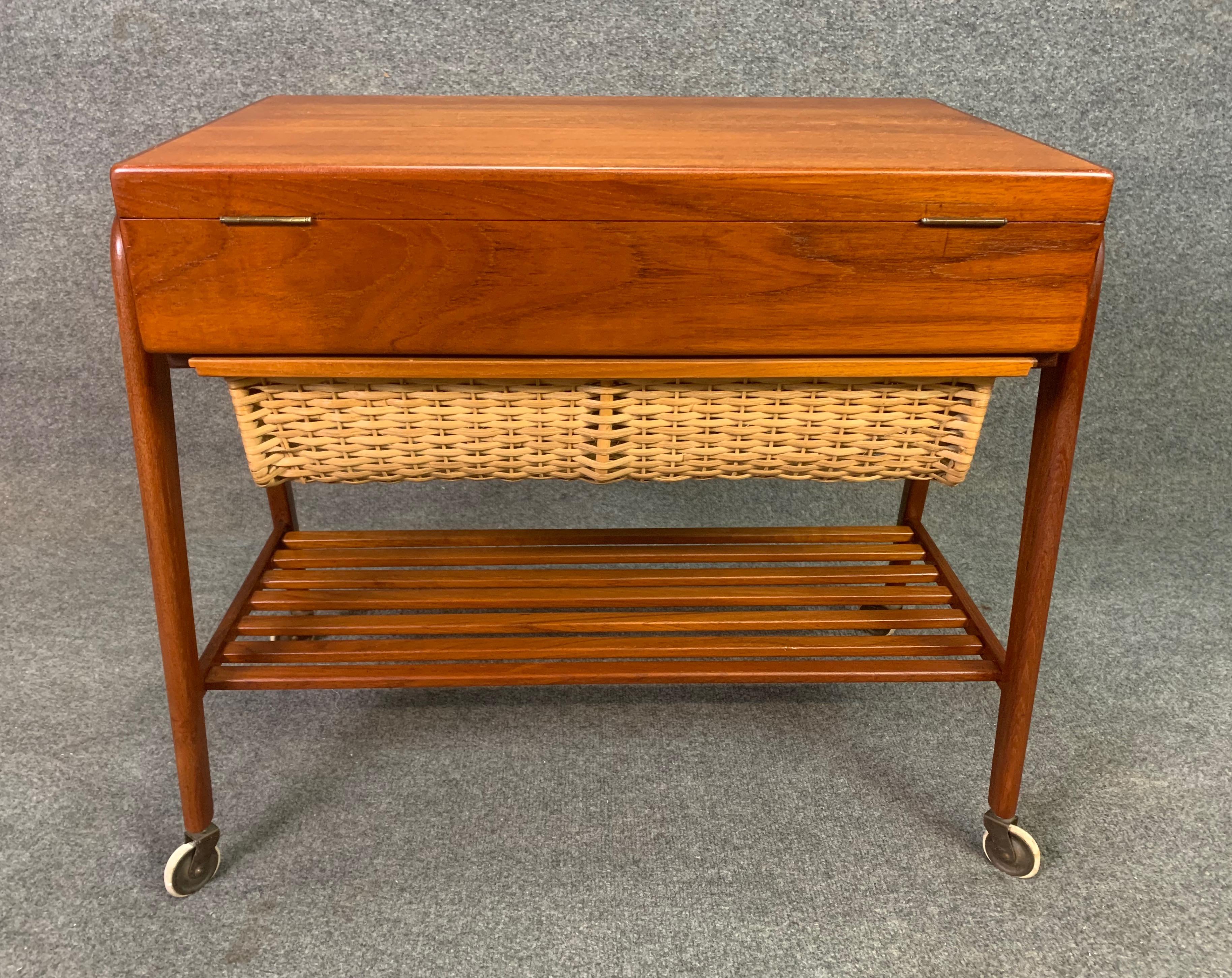 Here is a beautiful and rare Scandinavian Modern teak sewing cart designed by Poul Dinesen in Denmark in the 1960s.
This versatile piece, recently imported from Copenhagen to California before its refinishing, features a vibrant wood grain, a lift