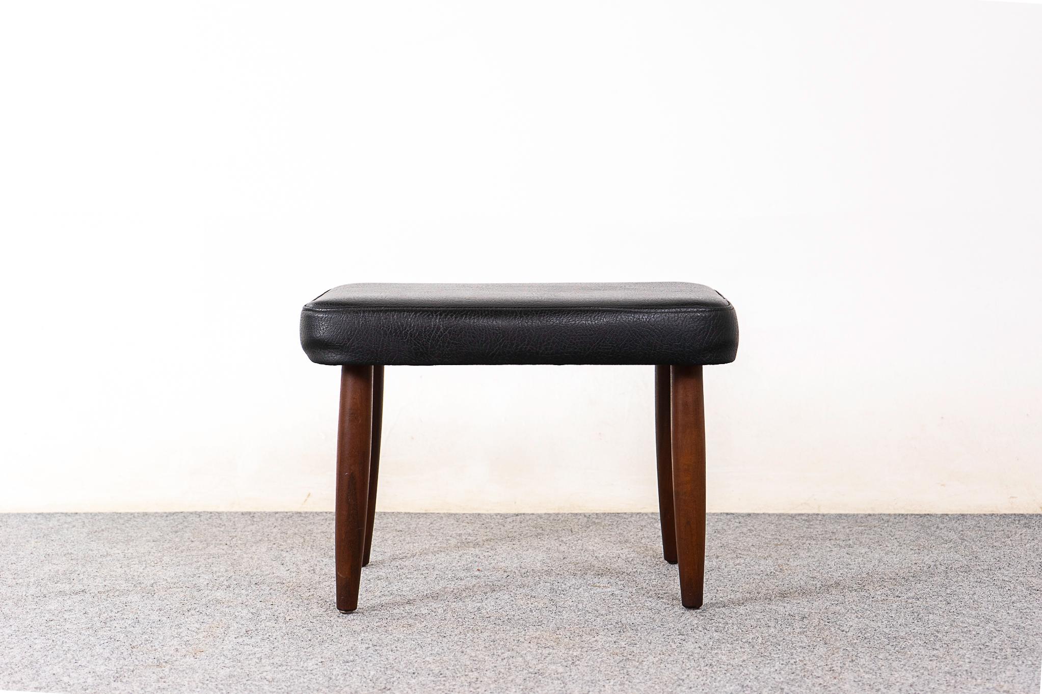 Teak Danish footstool, circa 1960's. Sleek conical legs and original vinyl upholstery with minor wear.
