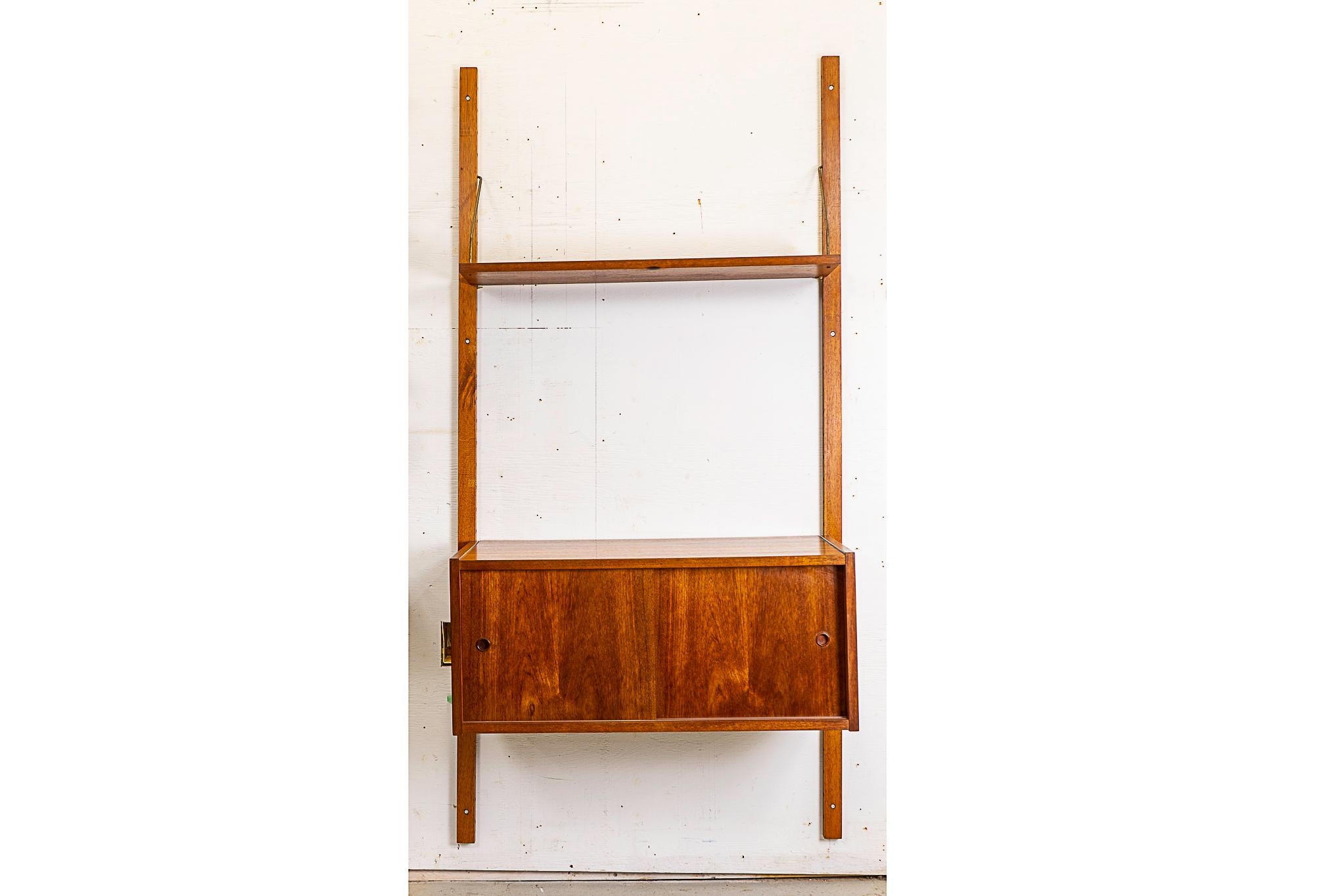 Teak Danish single bank wall system, circa 1960's. Sliding door cabinet with interior shelf and single adjustable upper shelf.

Please inquire for international and remote shipping rates.