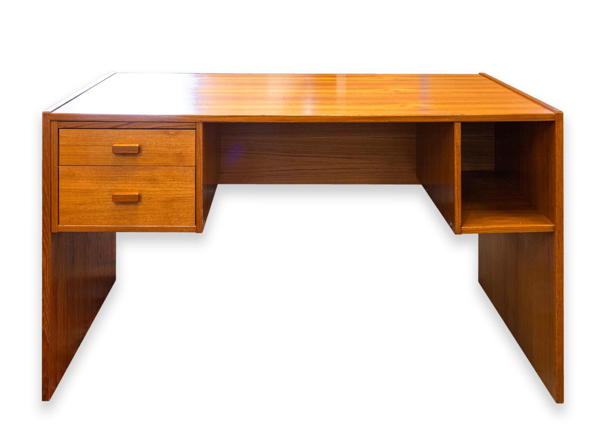 A Danish mid century modern desk by Jesper. A wonderful office desk featuring a full teak wood construction. The wood looks stunning, and is full of rich coloring and beautiful grain patterning. This desk has two pull out drawers on the left side,