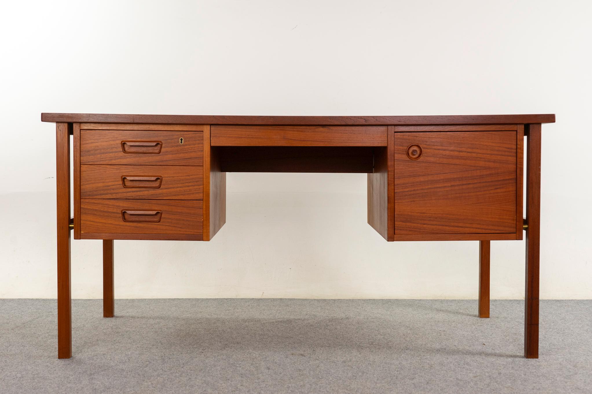 Teak Danish desk, circa 1960s. Beautiful, warm-toned book-matched veneer throughout. Original brass hardware, dovetail-constructed drawers with lovely finger pulls, and rear open cubbies. Finished on all sides, looks exceptional from every angle!