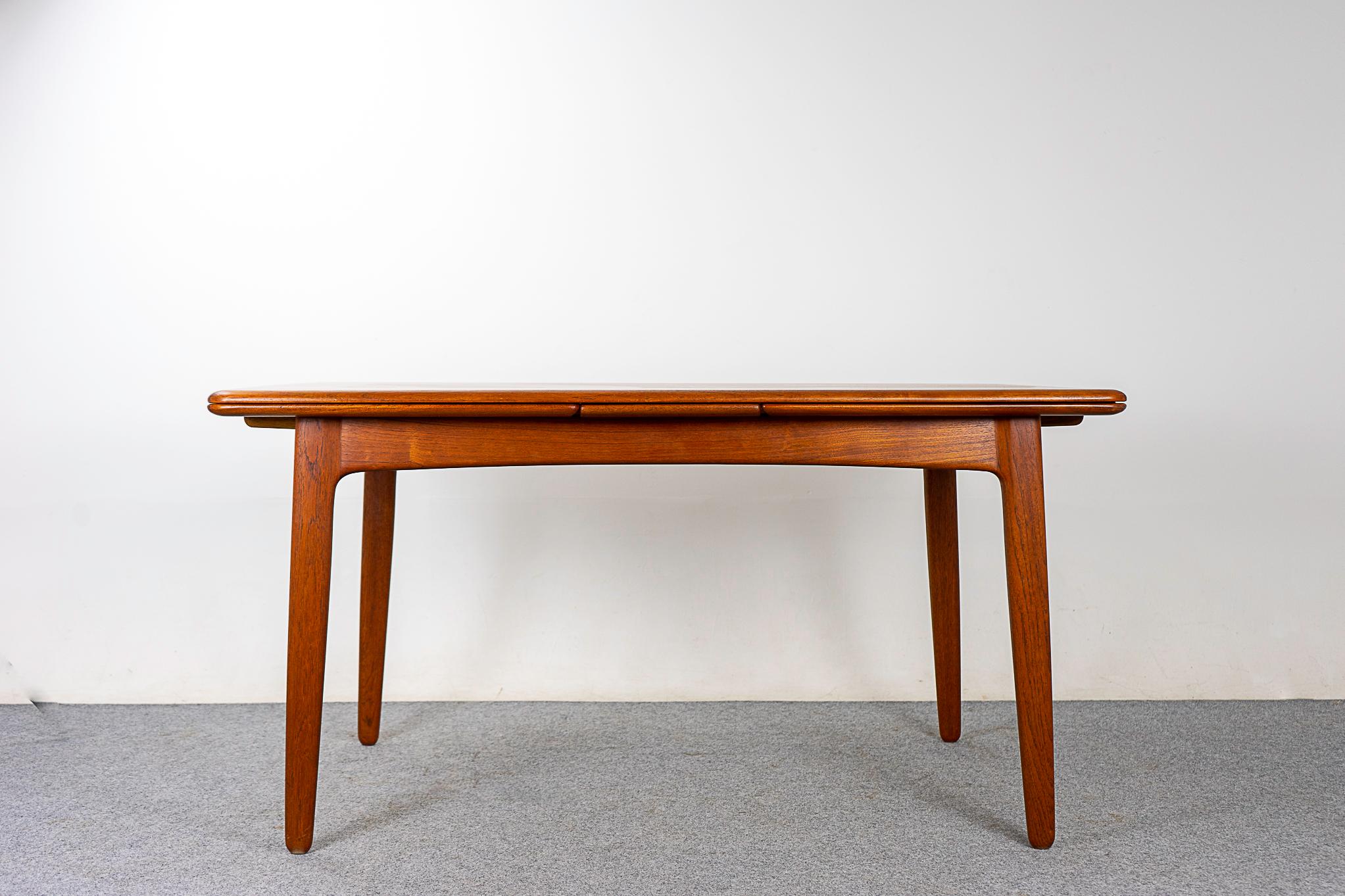 Teak draw leaf dining table by Svend Madsen for K. Knudsen, circa 1950s. A truly exceptional level of quality & construction. Richly grained teak with expertly bookmatched top surface, generous solid edging and gorgeous patina. Beautifully