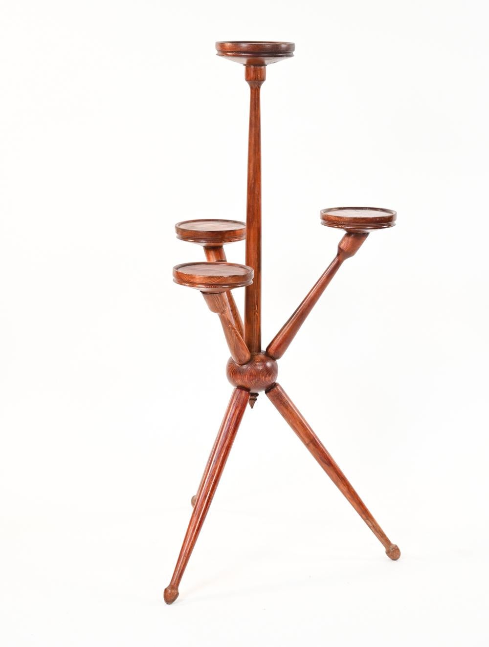An unusual Danish Mid-Century Modern multi-height four-tiered plant stand on Sputnik-reminiscent tripod base, in stained pine wood. Each tier has a 6