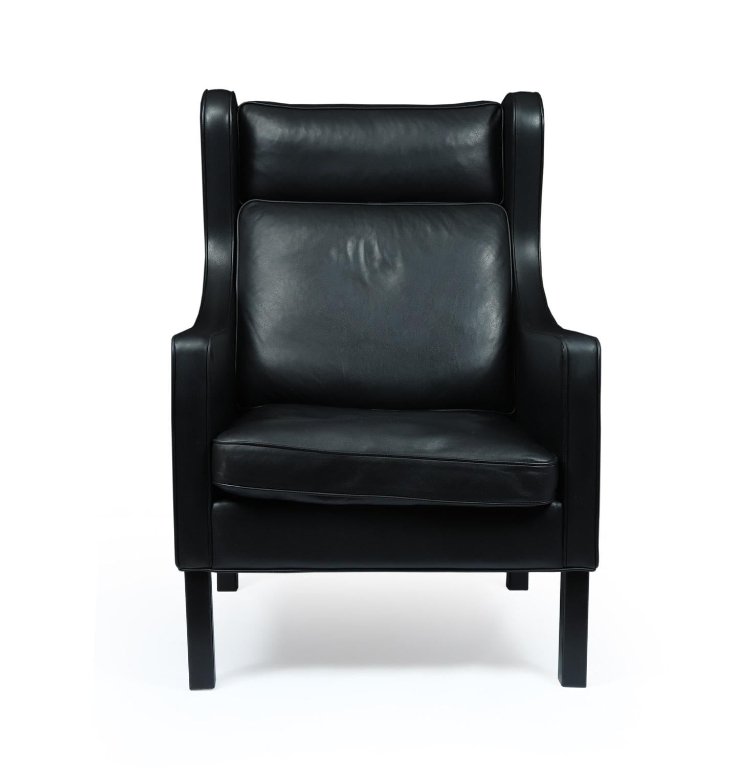 Danish wing chair in black leather by Hurup, circa 1980

This high back winged chair with black beech legs was produced in thick excellent quality, fully analine leather by the renowned furniture makers Hurup in Denmark, circa 1980s. The chair