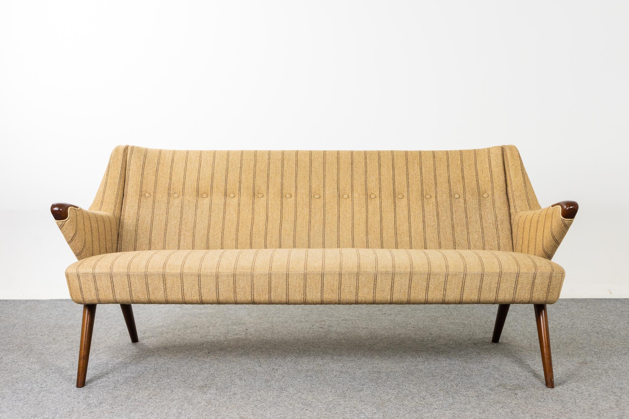 Teak and wool Danish modern sofa, circa 1960's. Stunning three seat sofa with elegant lines and thoughtfully designed details. Compact footprint make this the perfect seating solution for urban dwellers in cozy lofts or condos. Great construction
