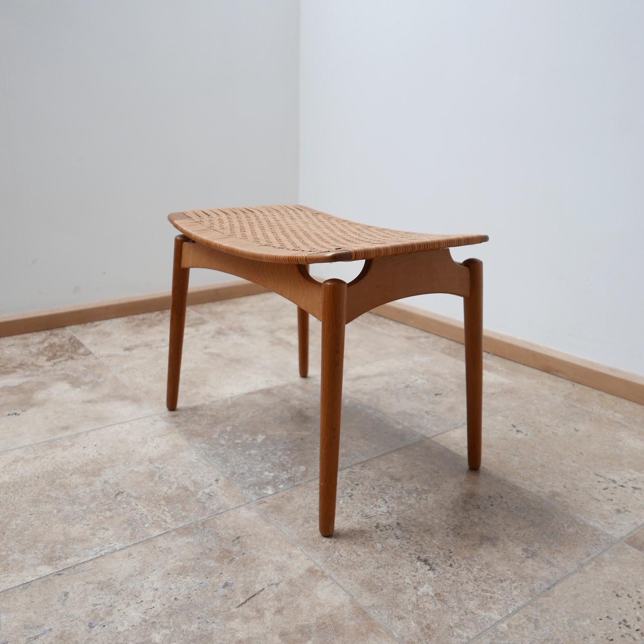 A stylish midcentury stool by Sigred Omann, designed for Ølholm Møbelfabrik.

Denmark, circa 1950s.

Cane top, the base is either oak or a light teak.

Amazing stance and form.

Perfect as an occasional stool or a side table for books and
