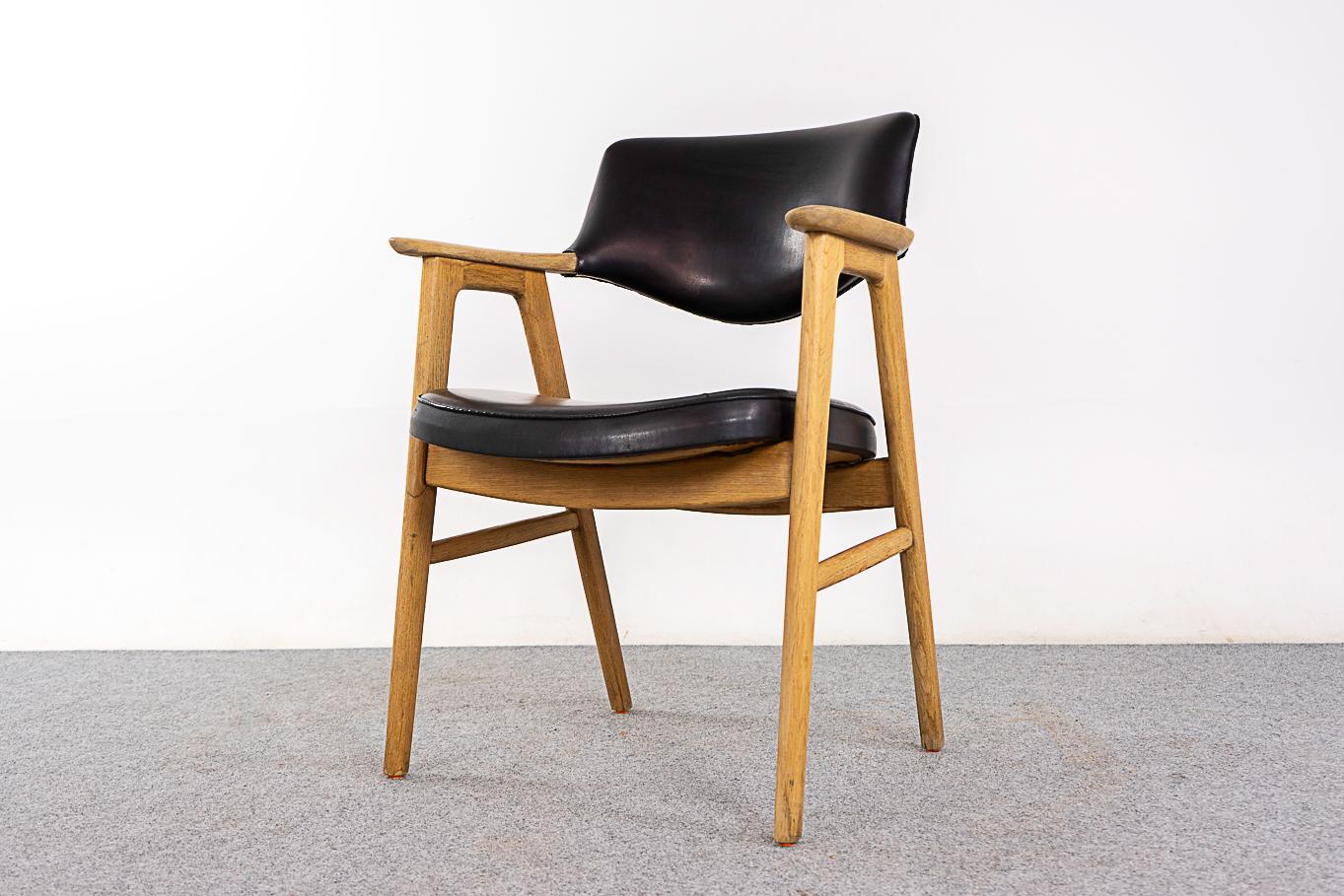 Danish Modern oak chair by Erik Kirkegaard, circa 1960's. This beautifully sculpted solid oak frame offers comfort without an imposing footprint.  Chair shows original upholstery with wear.

Underside of chair shows Erik Kierkegaard maker's