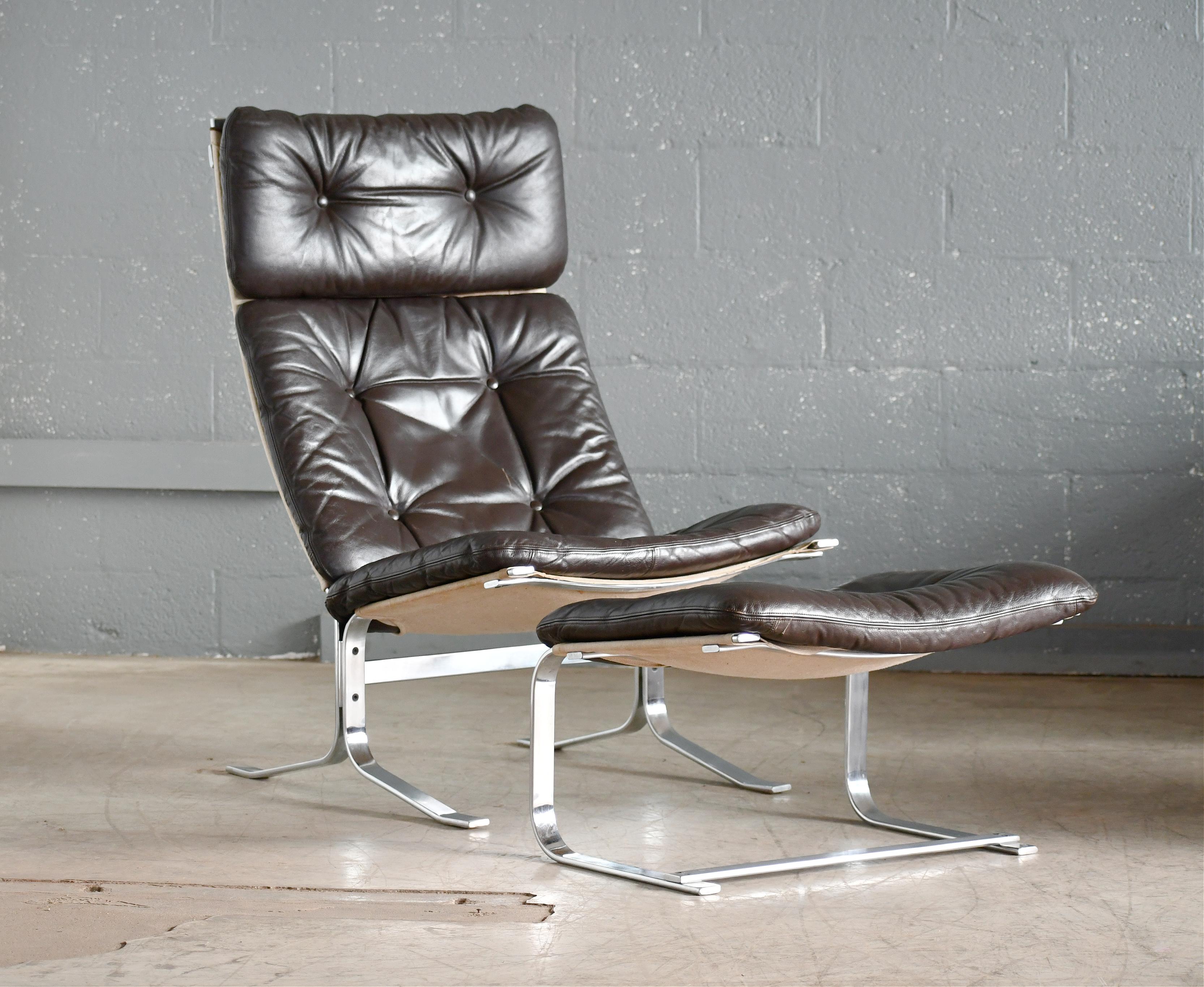 Beautiful easy chair in the style and tradition of Erik Jorgensen and Poul Kjaerholm with supple leather and cushions on a heavy gauge base of polished steel. Very reminiscent of the production quality seen in Erik Jorgensen's famous Corona chair.