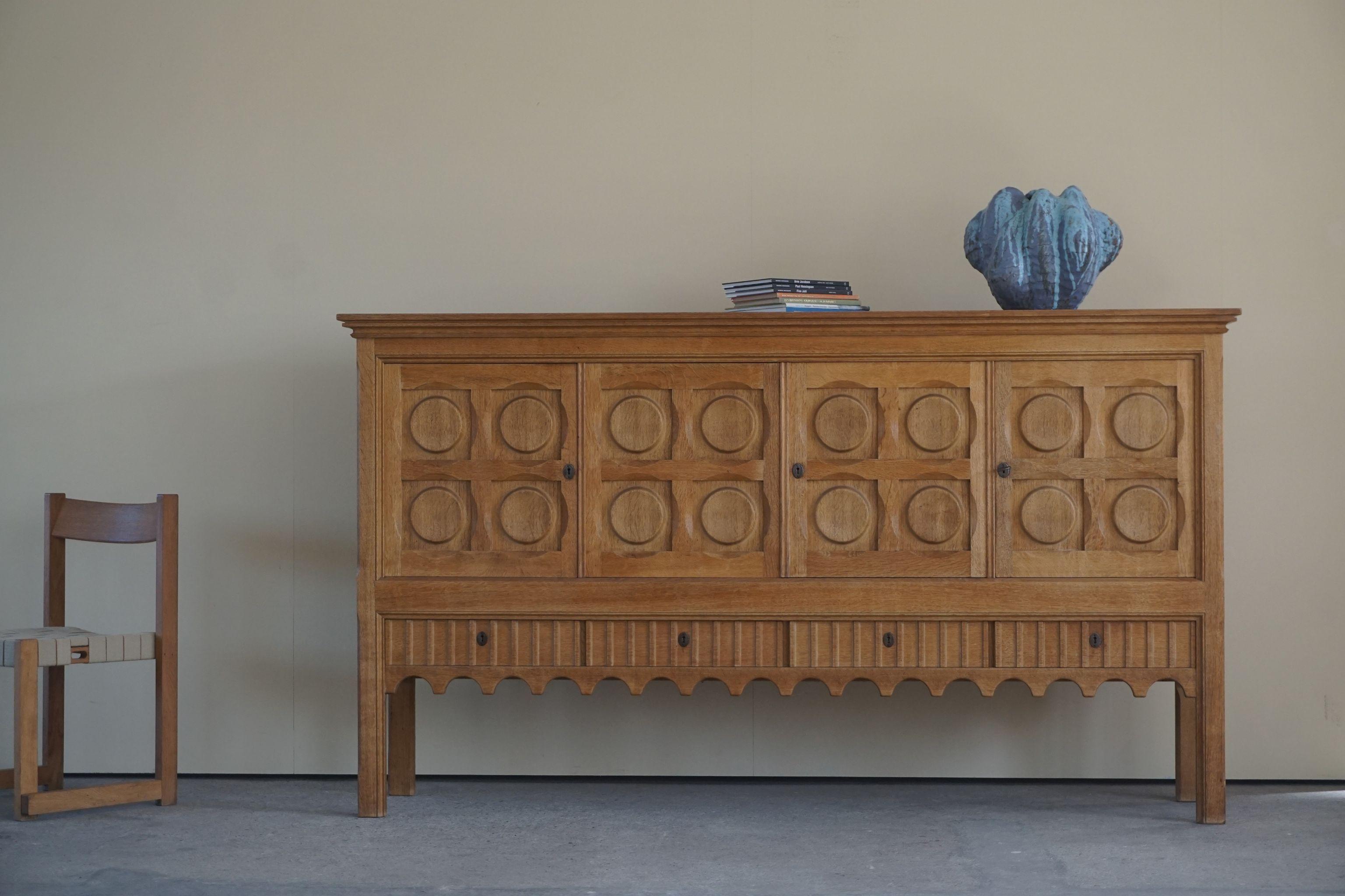 Danish Mid Century rectangular brutalist sideboard, made in solid Oak, ca 1950s

A great patina and a nice sculptural front design. 

Goes well in every kind of interior. From the classic to the modern home.