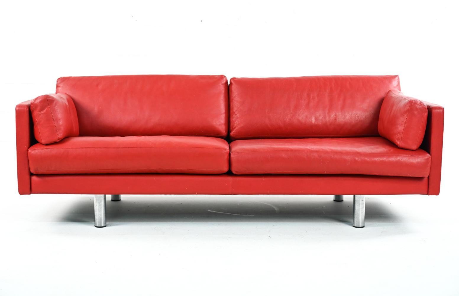 Danish mid-century sofa upholstered in red leather with chrome legs.