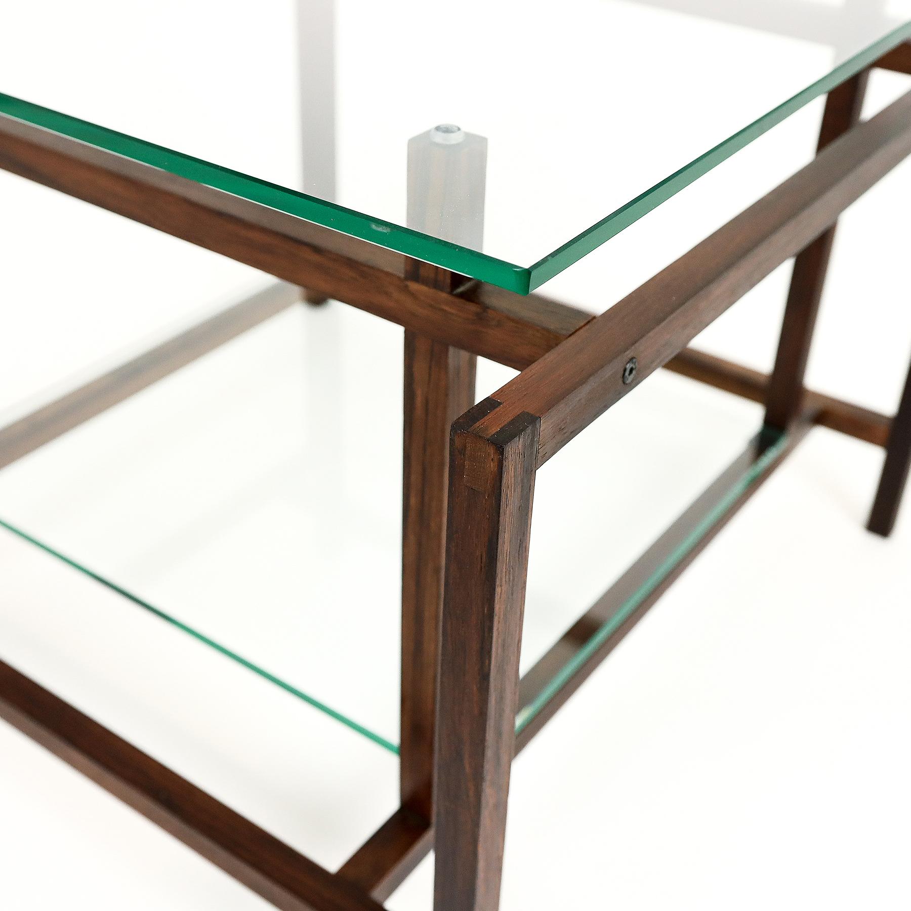 Danish Mid century rosewood and glass two tier coffee or side table designed by Henning Norgaard for Komfort Mobler, 1960s.

Unfortunately Henning Norgaard, despite many searches, is one of those designers who remains largely unknown. There’s no